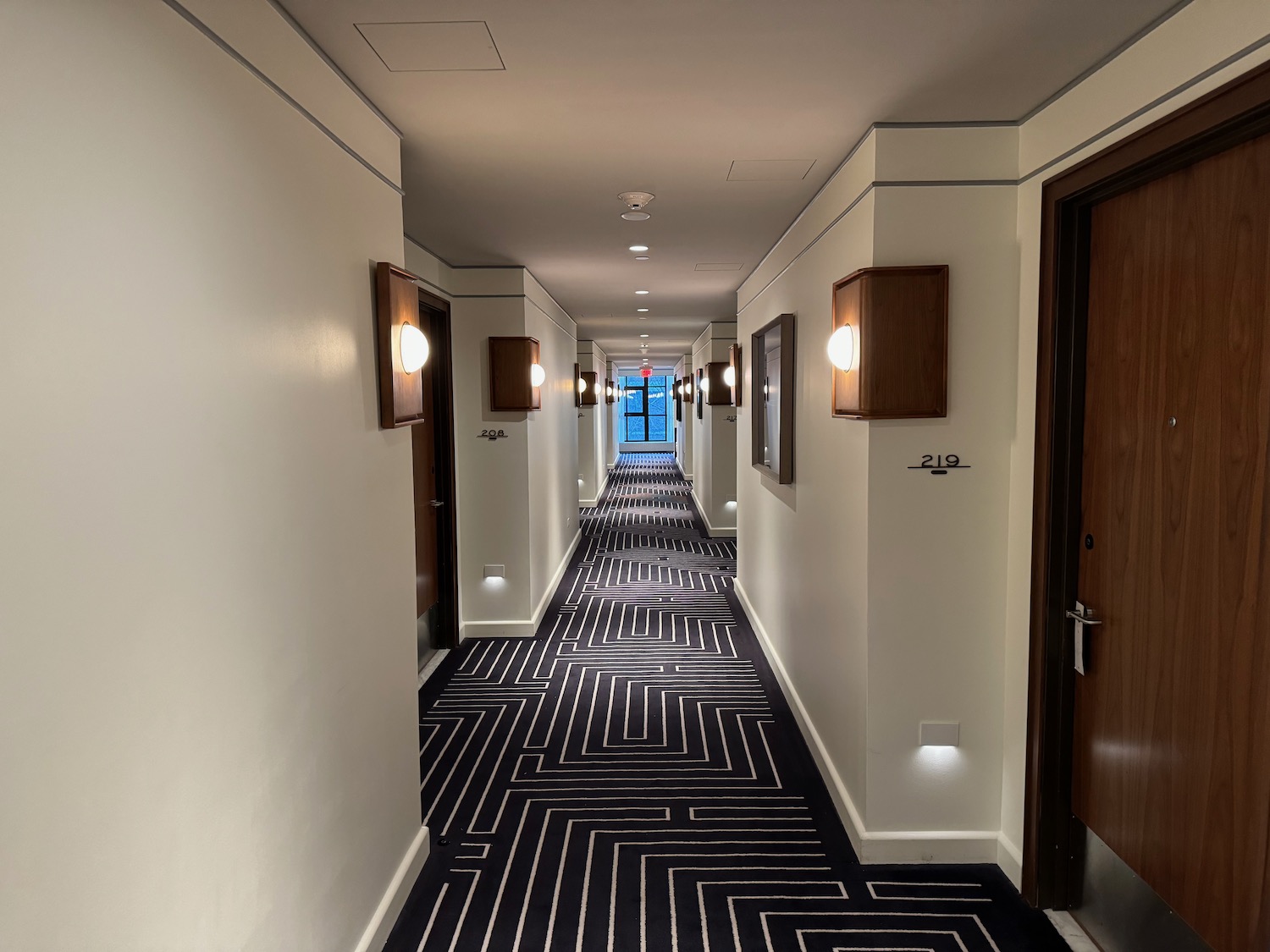 a hallway with black and white carpet