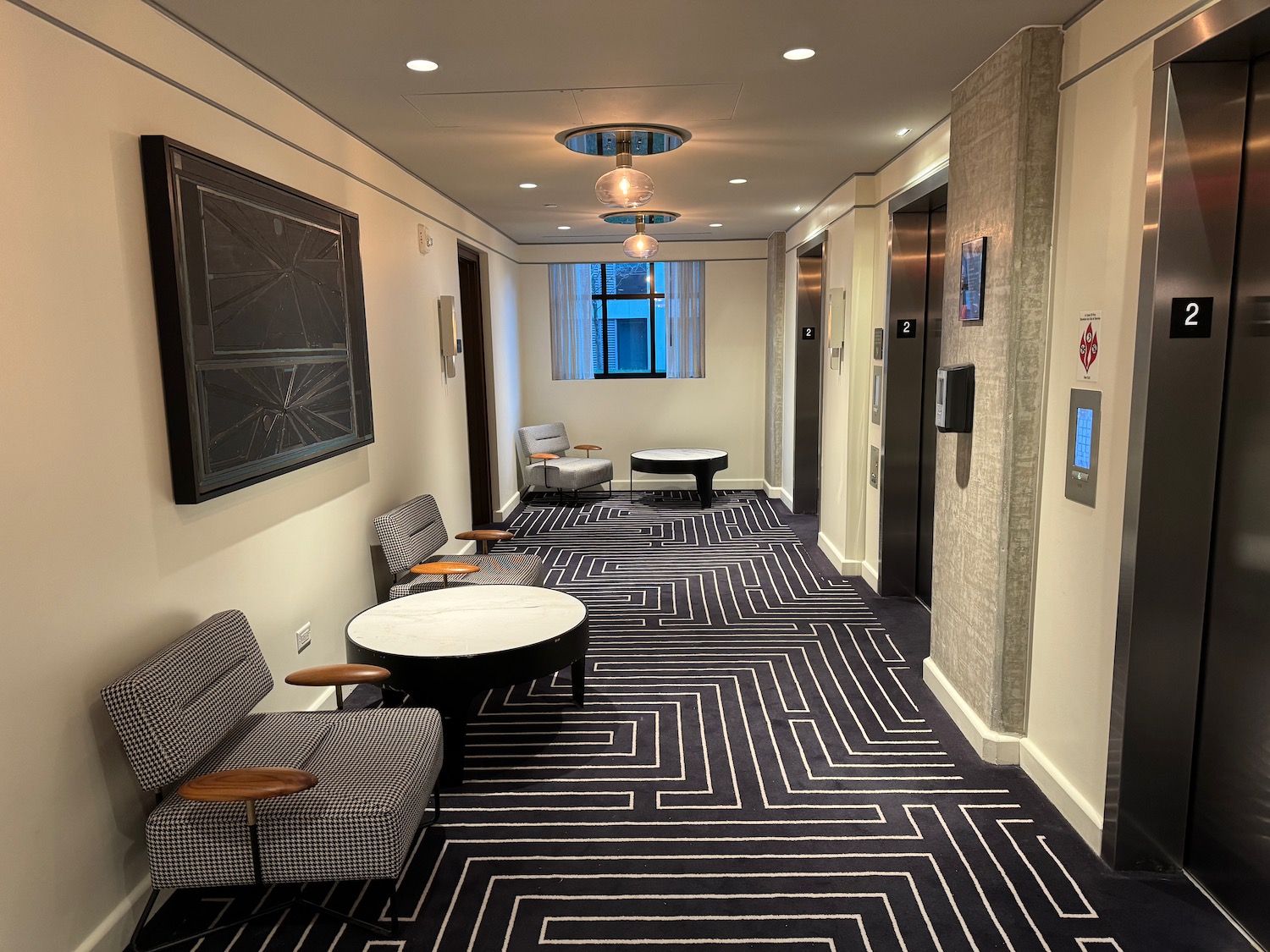 a hallway with chairs and tables