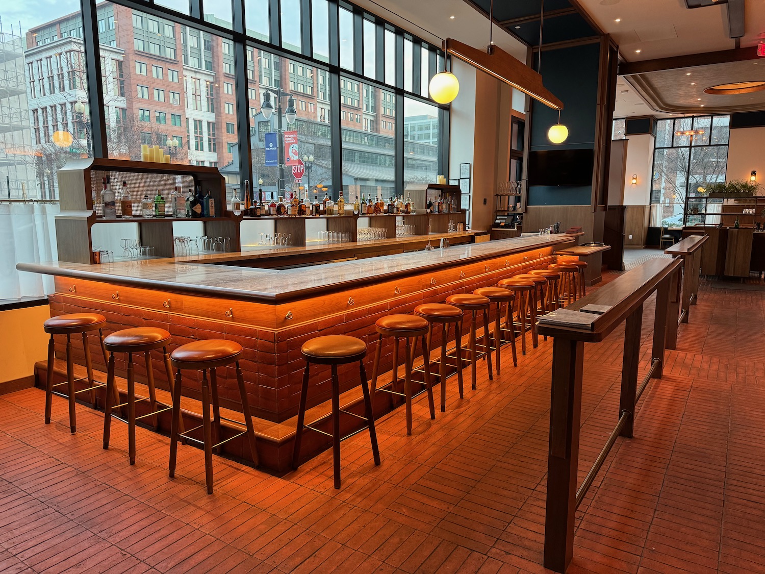 a bar with stools and a long counter