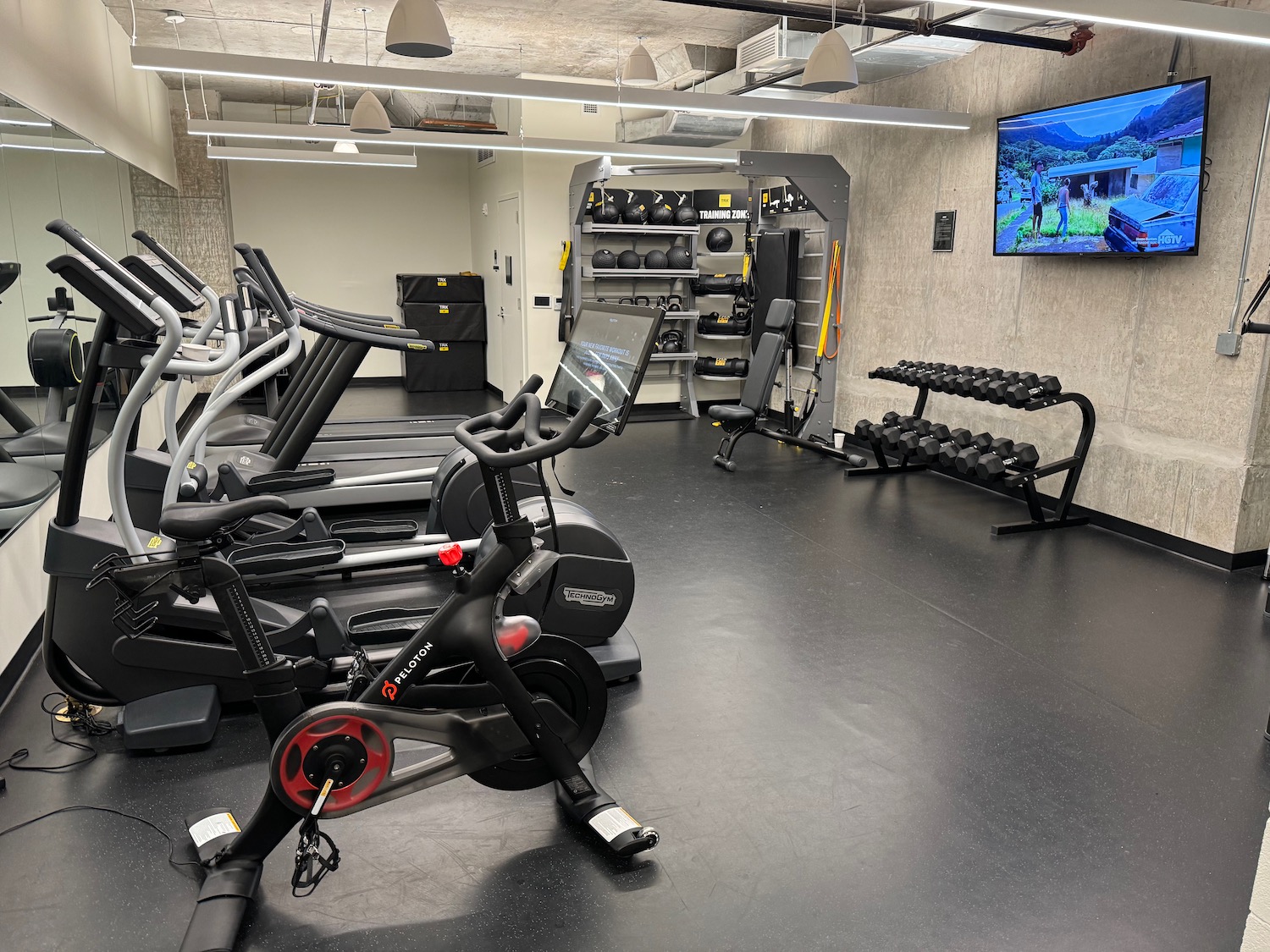 a gym with exercise bikes and a television