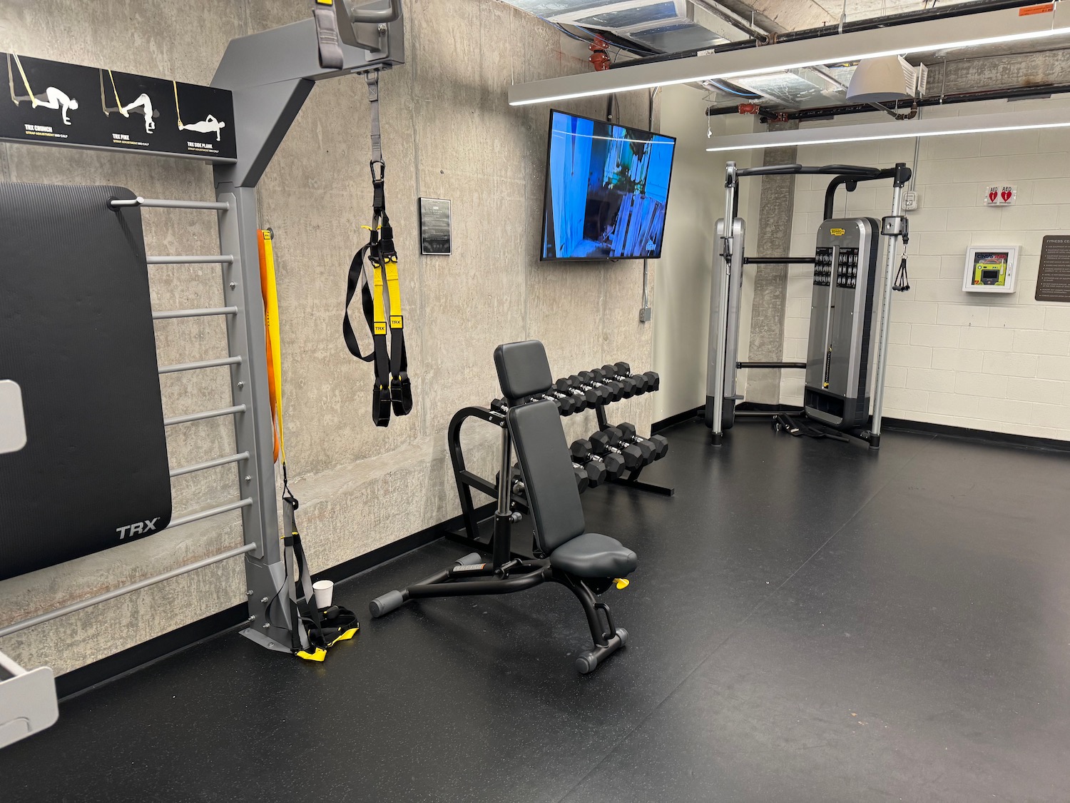 a gym with weights and a tv