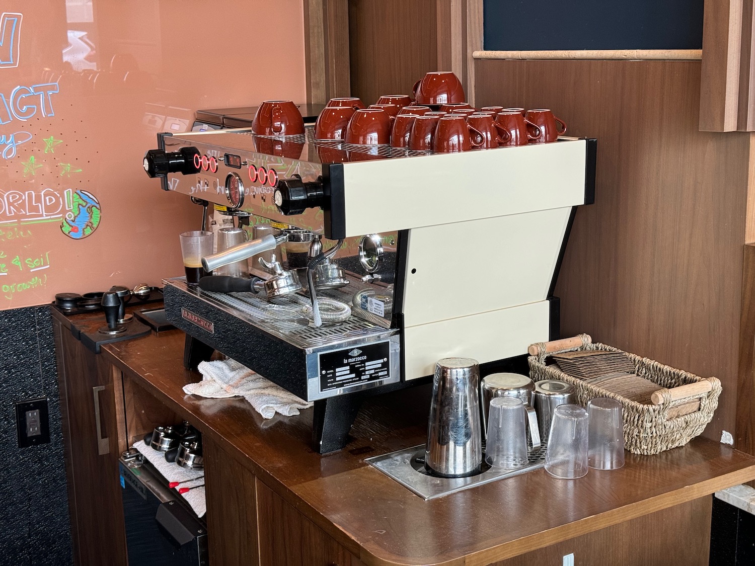 a coffee machine with many cups on top of it