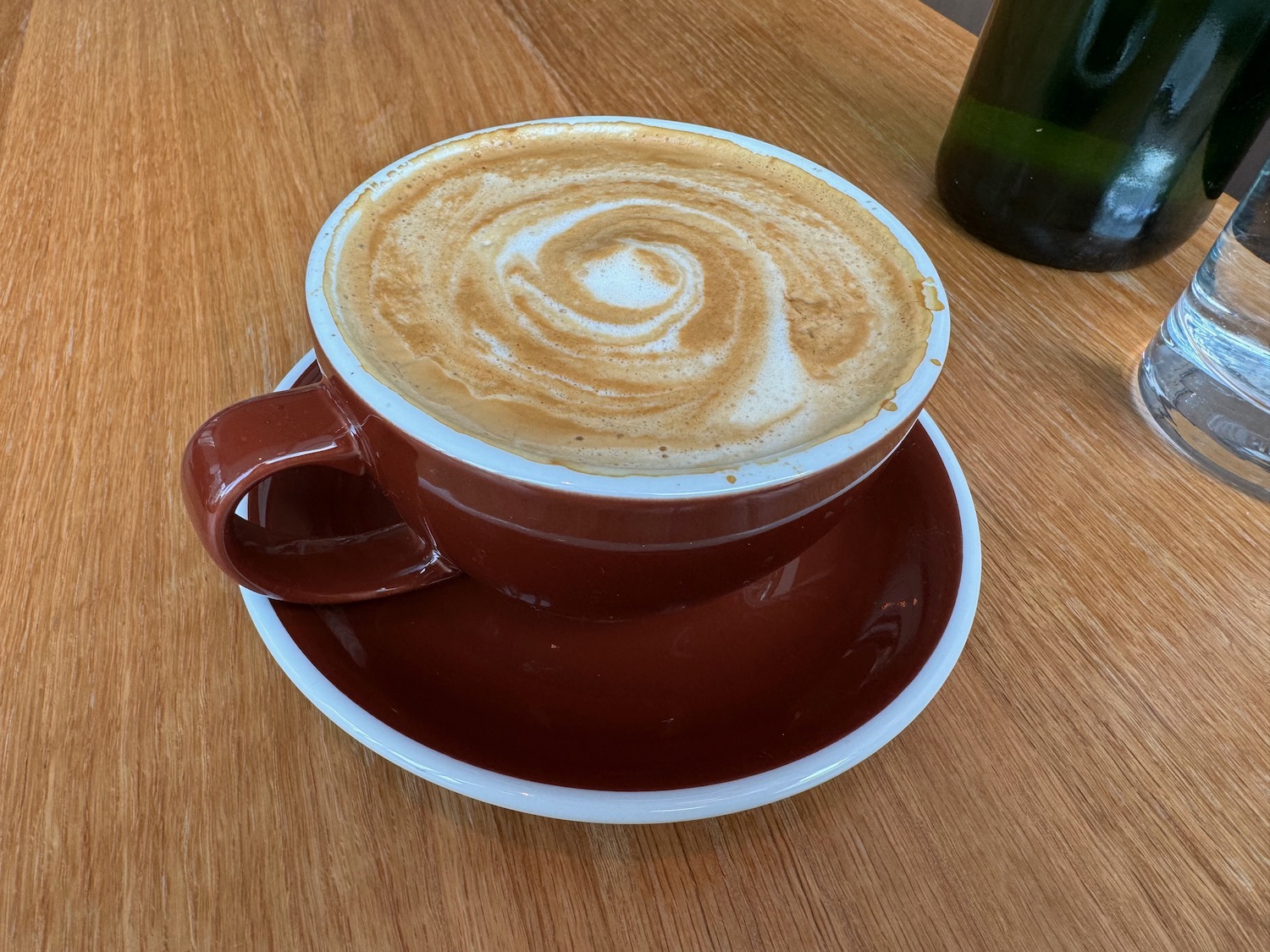 a cup of coffee with a swirl of foam on top