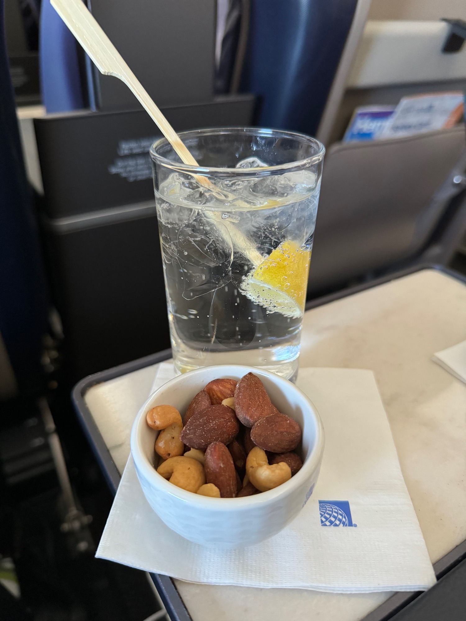 a bowl of nuts and a glass of water