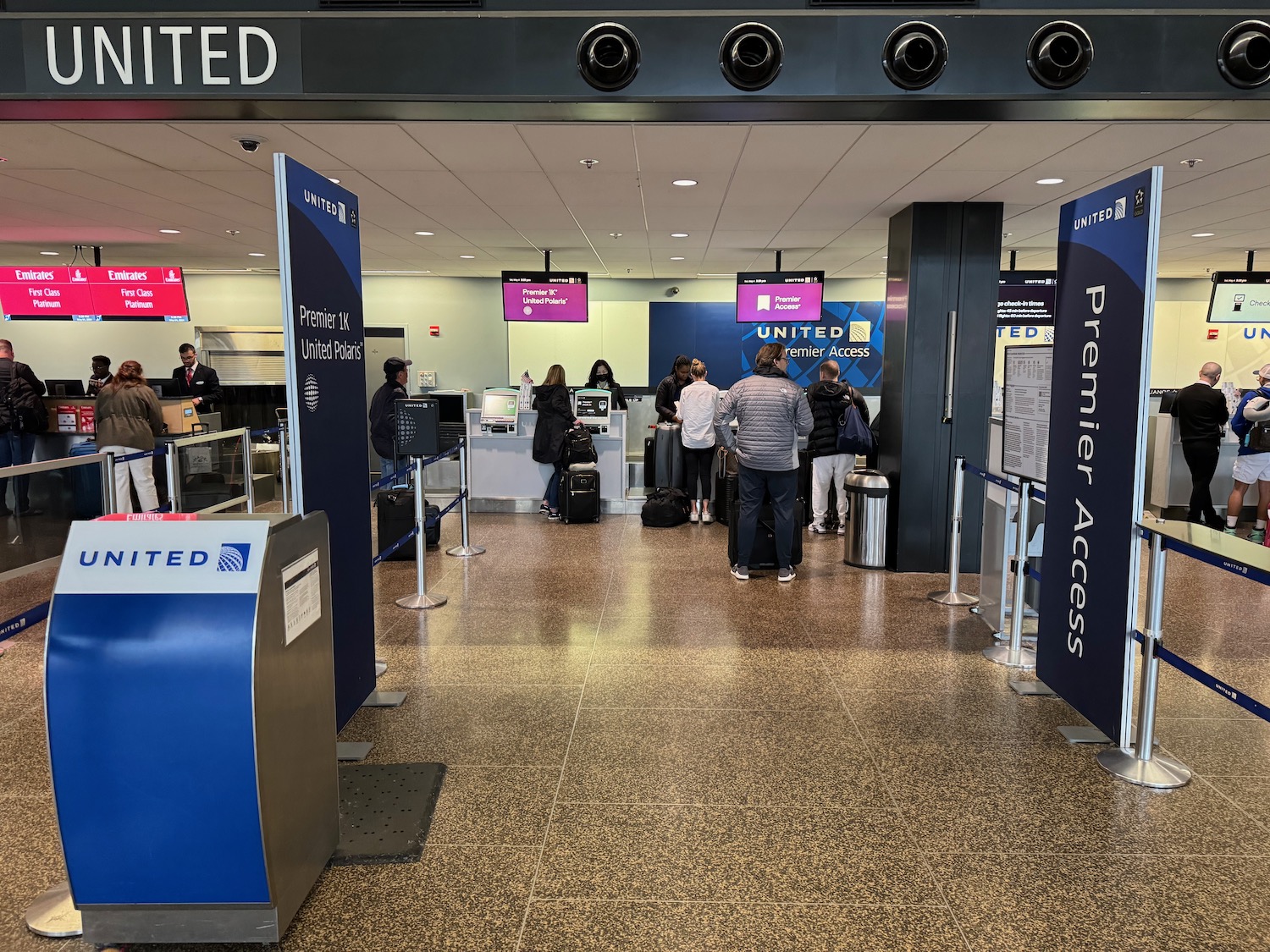 people standing in a line at an airport