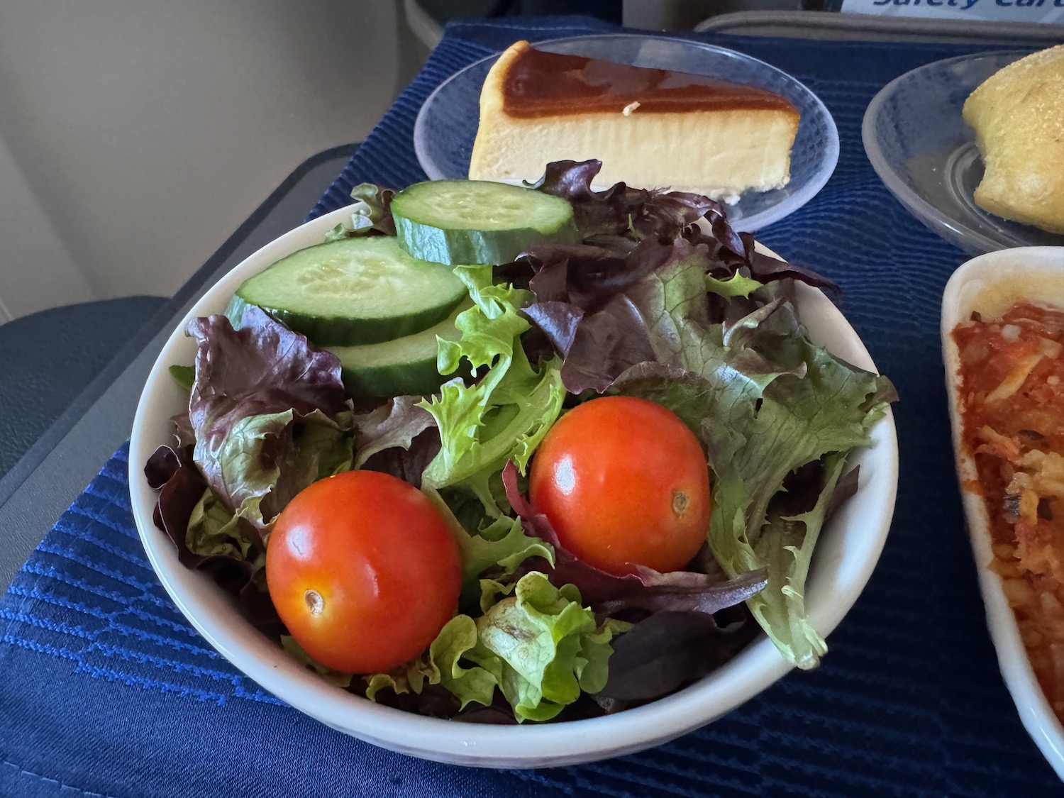 a bowl of salad with cucumbers and tomatoes