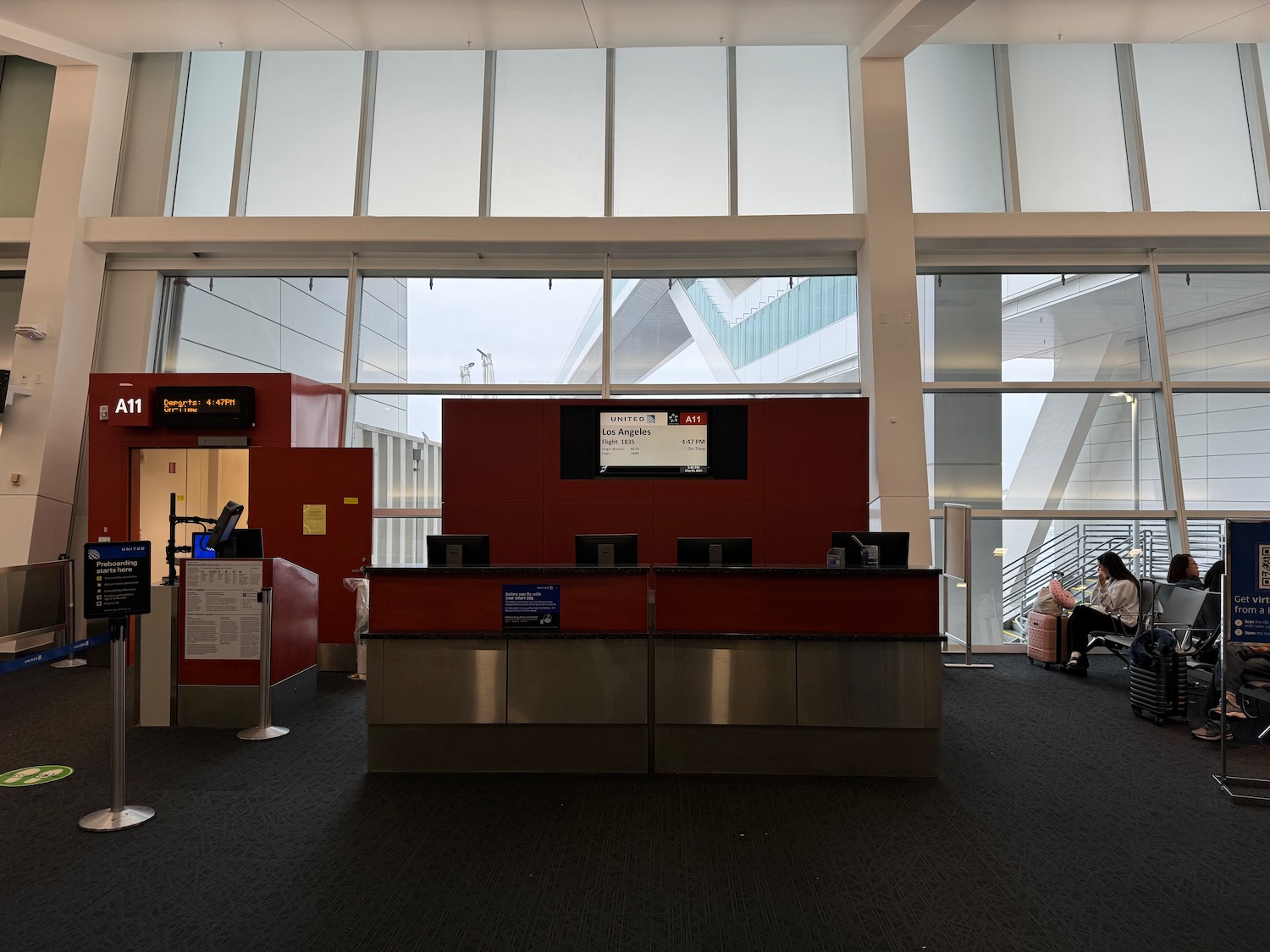 a person sitting in a chair in an airport