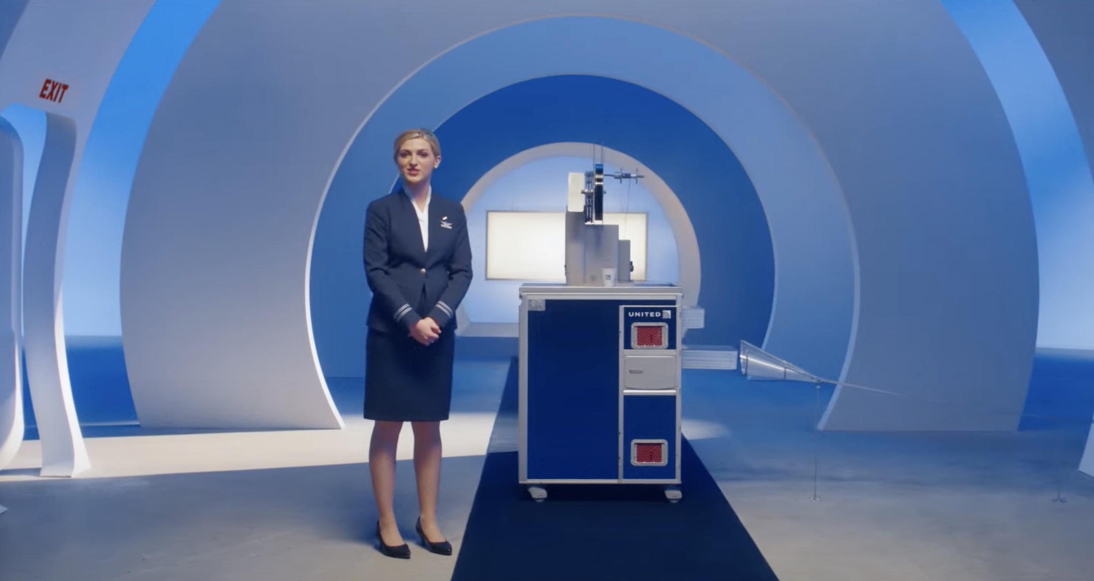 a woman standing in a room with a blue and white circle