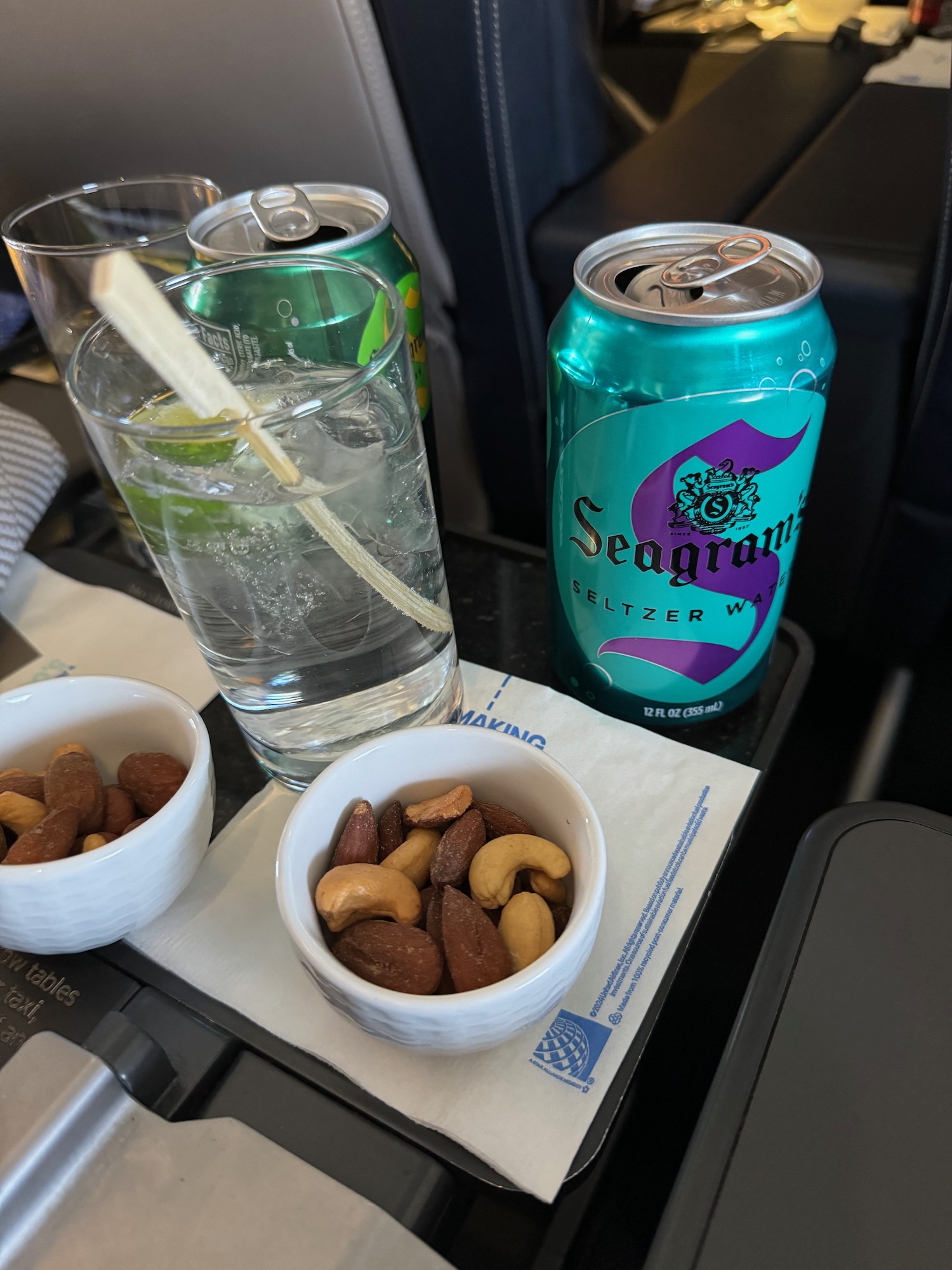 a bowl of nuts and a drink on a table