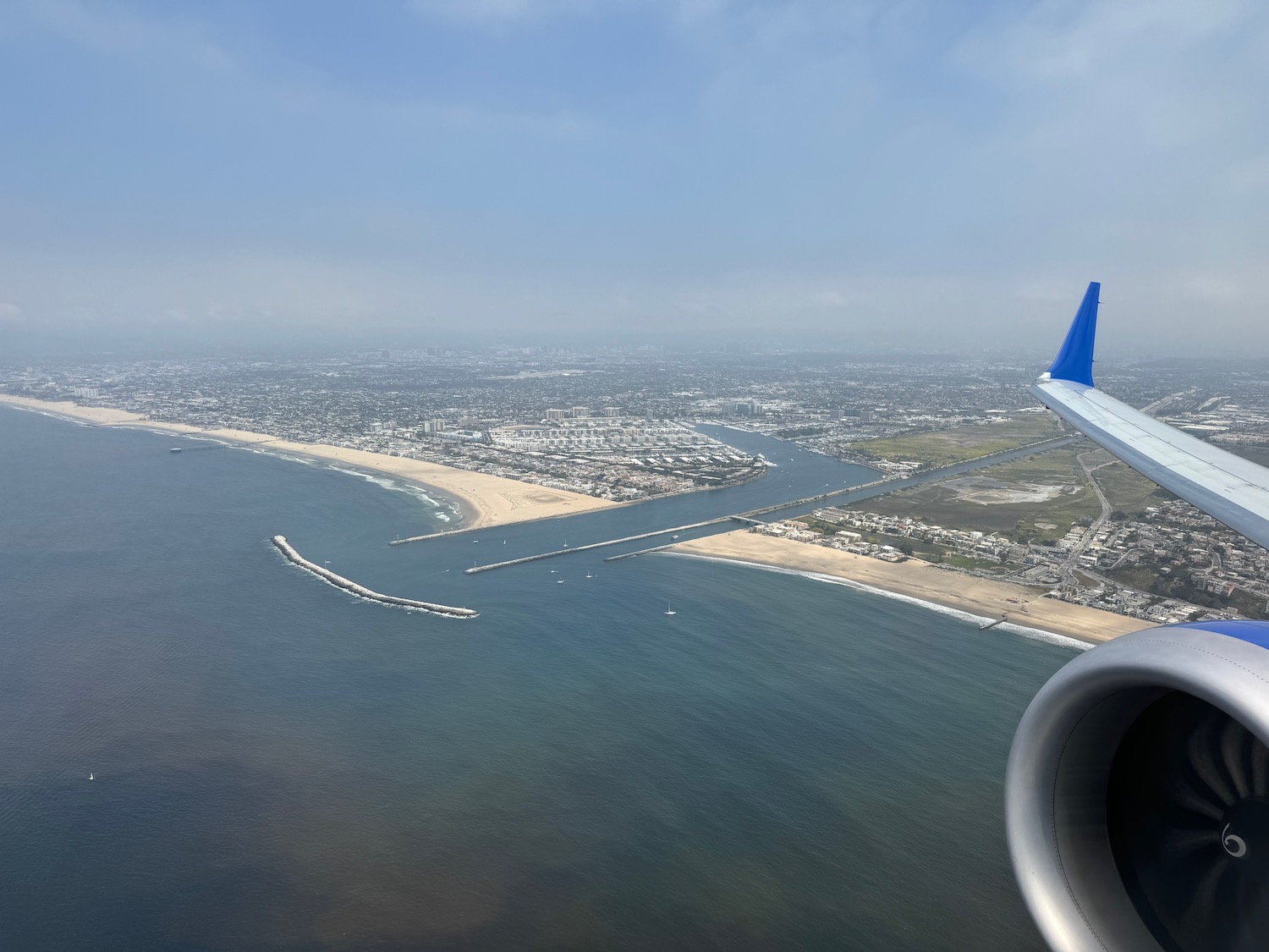 an airplane wing and a body of water