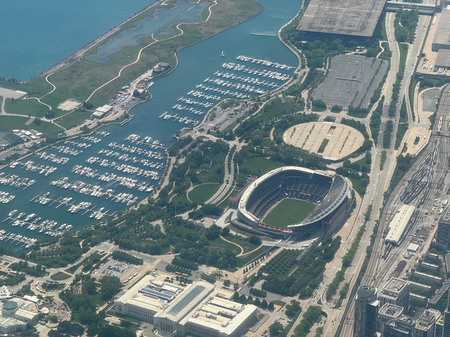 an aerial view of a stadium and a body of water