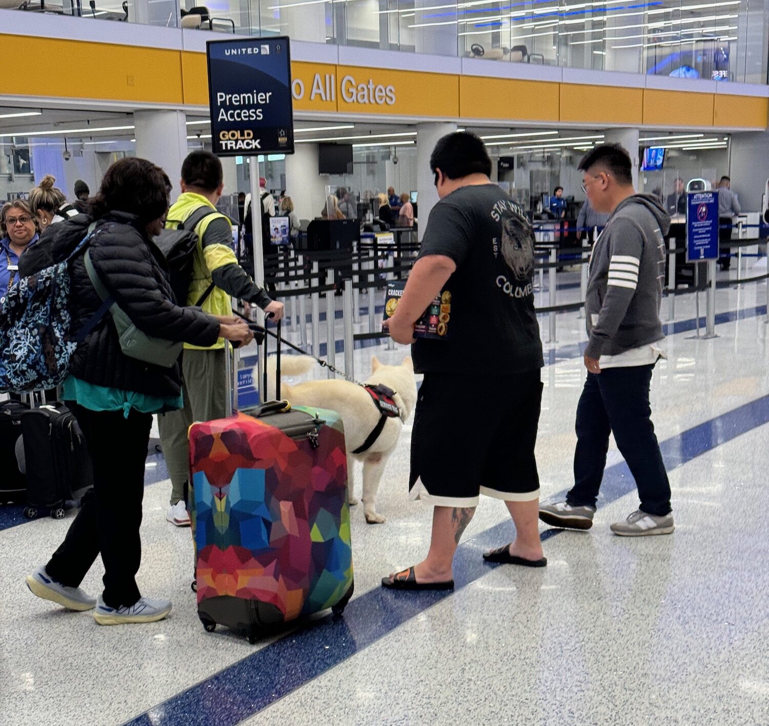 a group of people with luggage in an airport