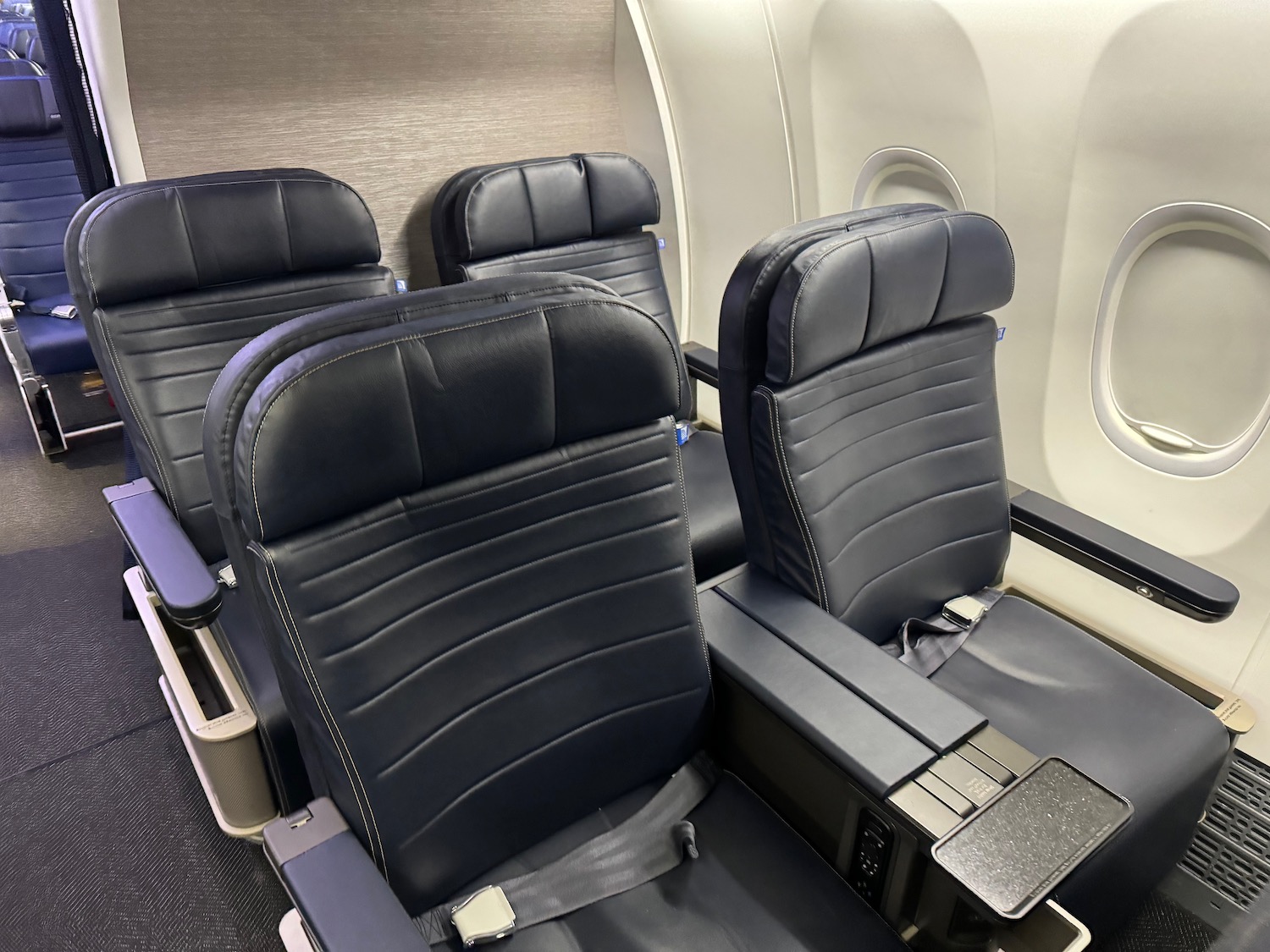 a row of black seats in an airplane