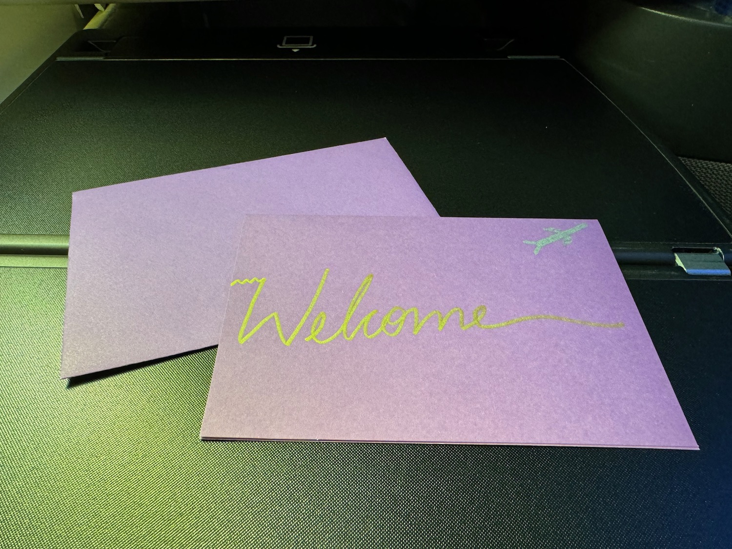 a purple envelopes with yellow writing on it