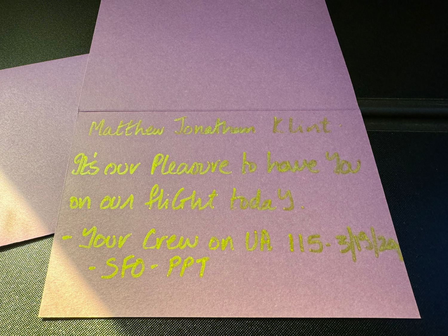 a purple envelope with yellow writing on it