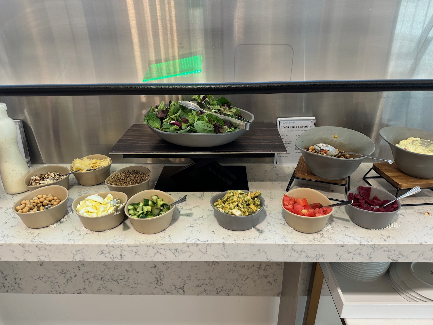 a salad bar with bowls of food