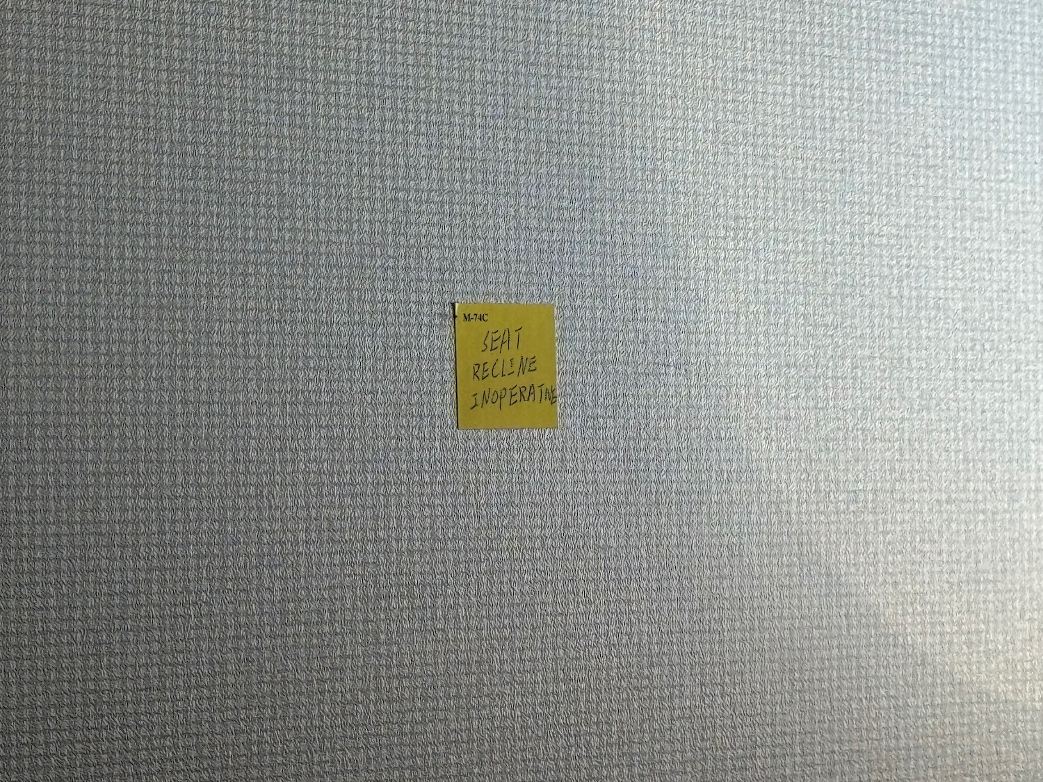 a yellow note on a grey surface