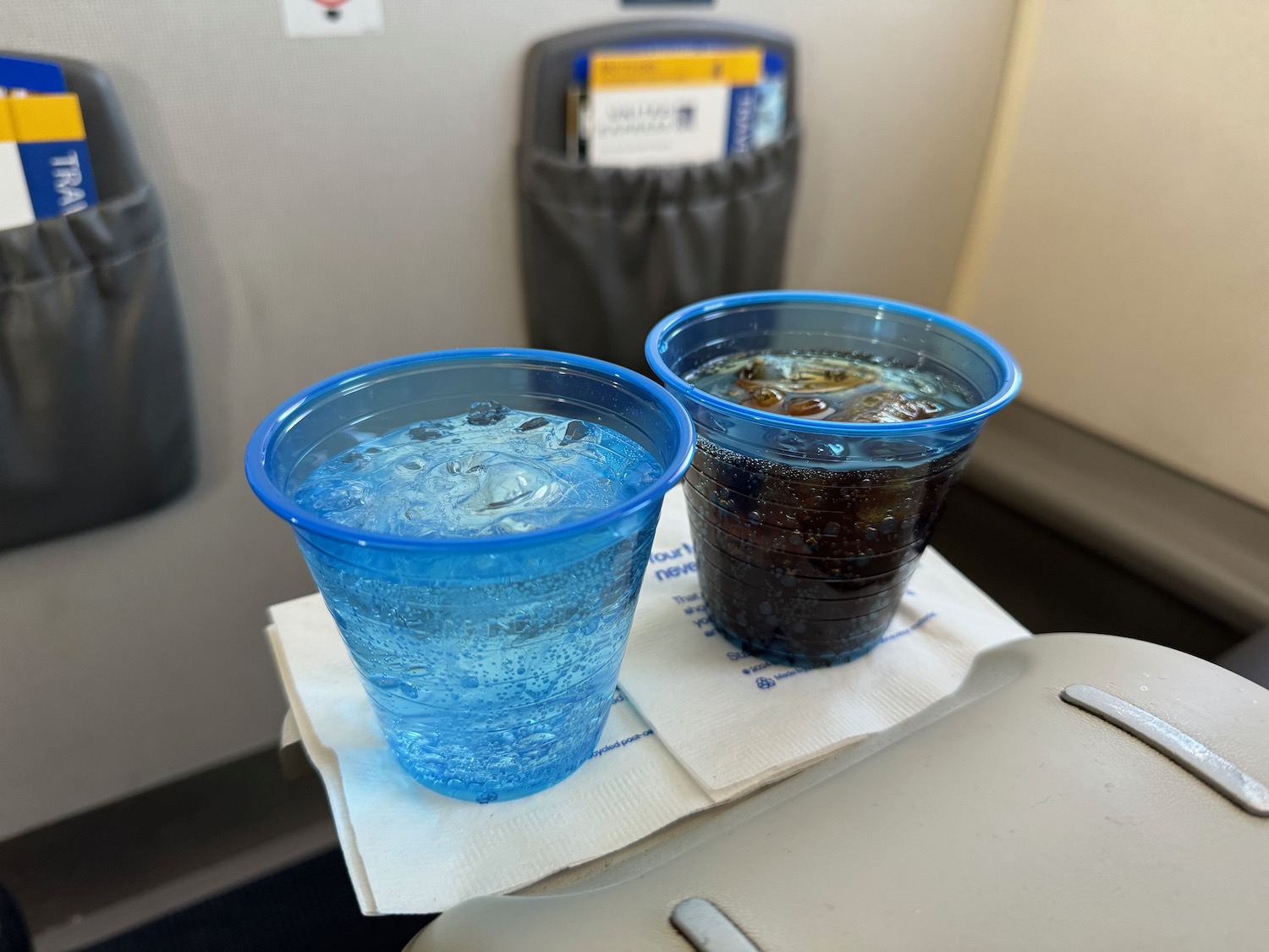 two plastic cups of water on a napkin