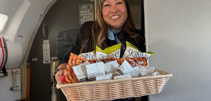 a woman holding a basket of snacks