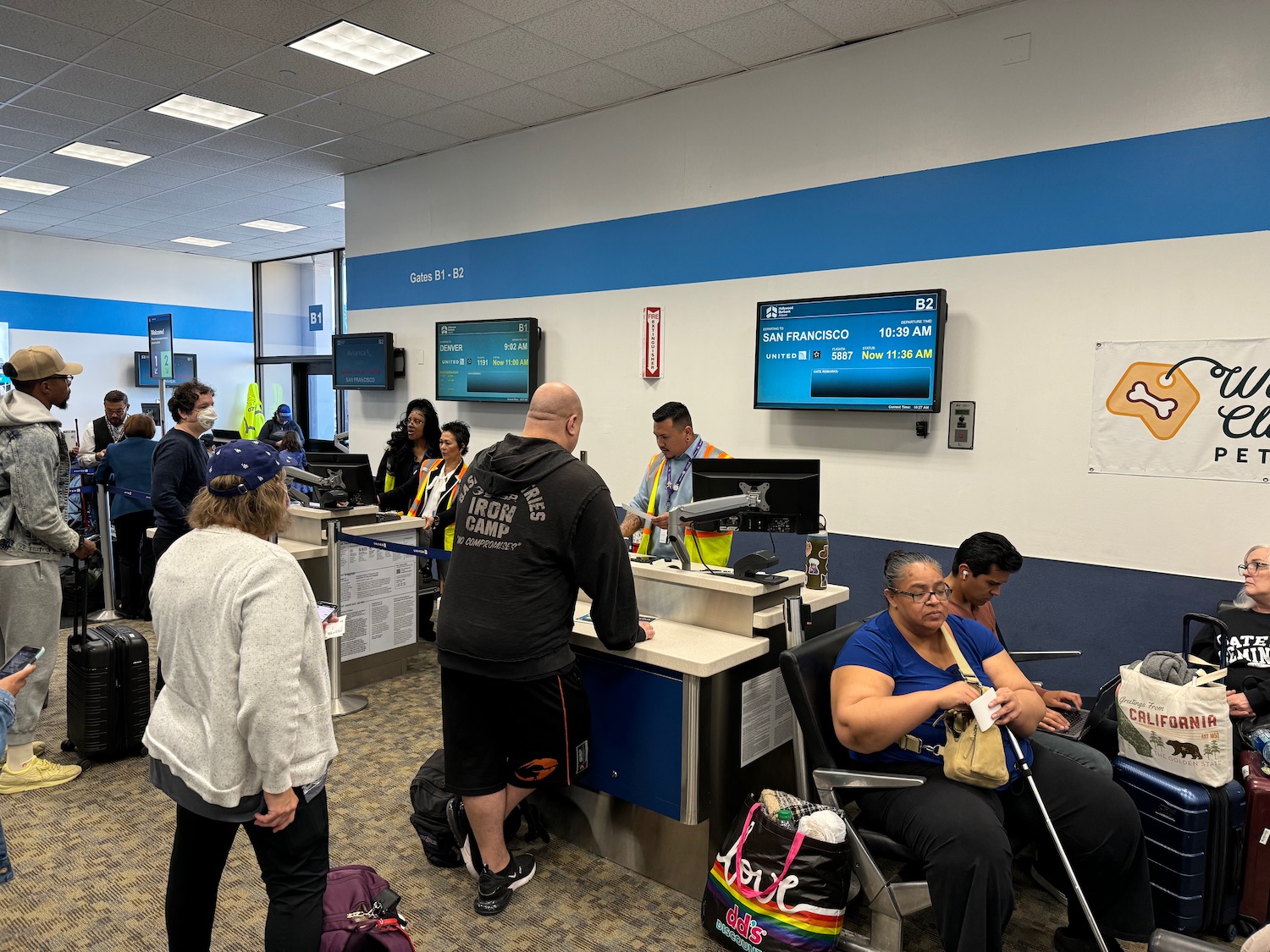 people in a queue at a check-in counter