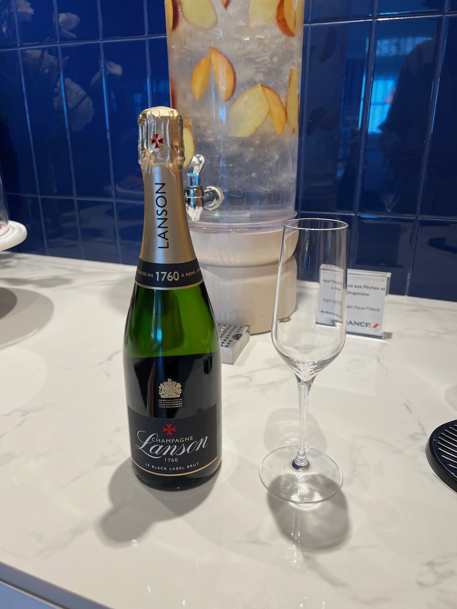 a bottle of champagne next to a glass of water