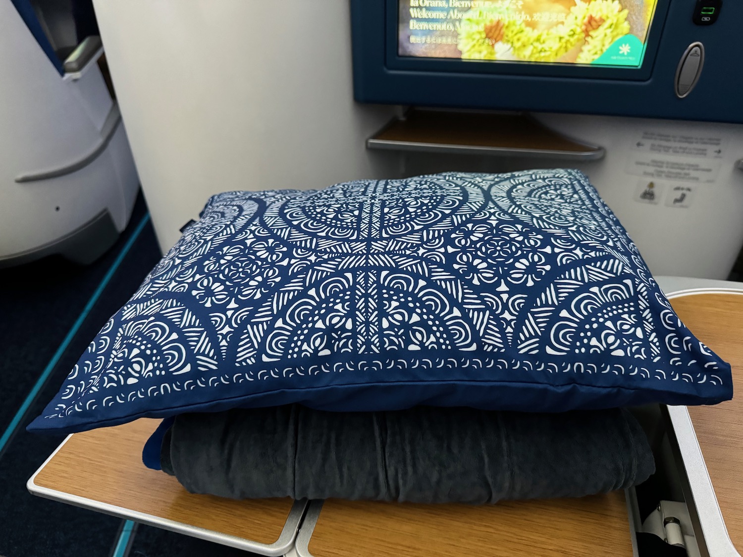 a pillow on top of a stack of clothes