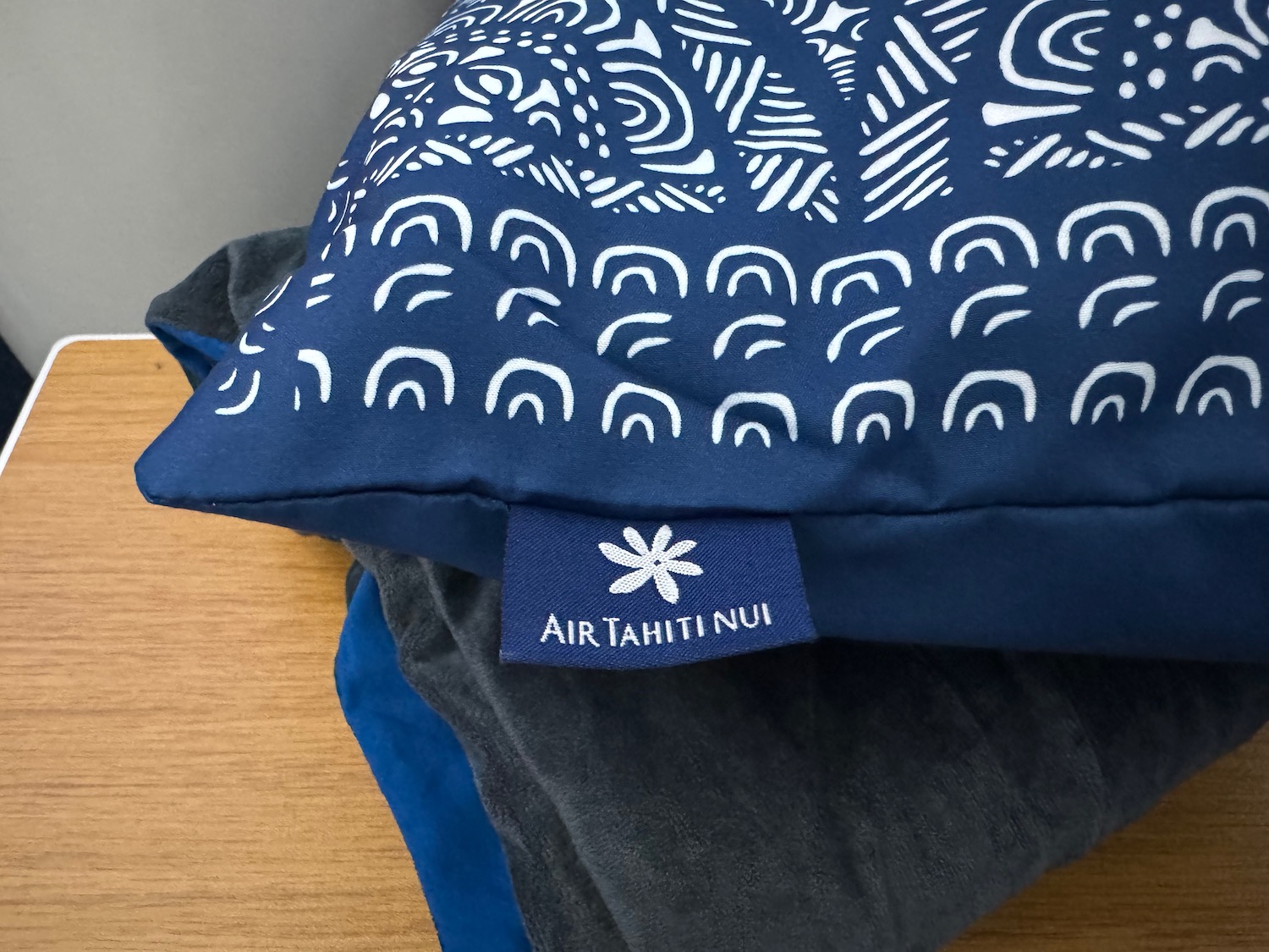 a blue pillow with white design on it