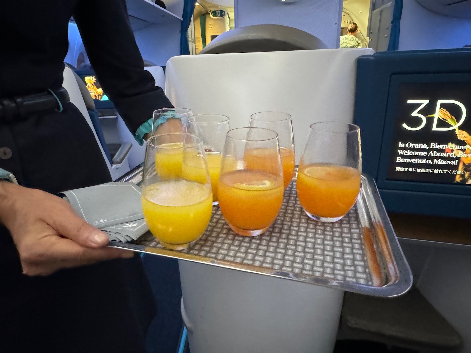 a tray of glasses with orange liquid on a tray