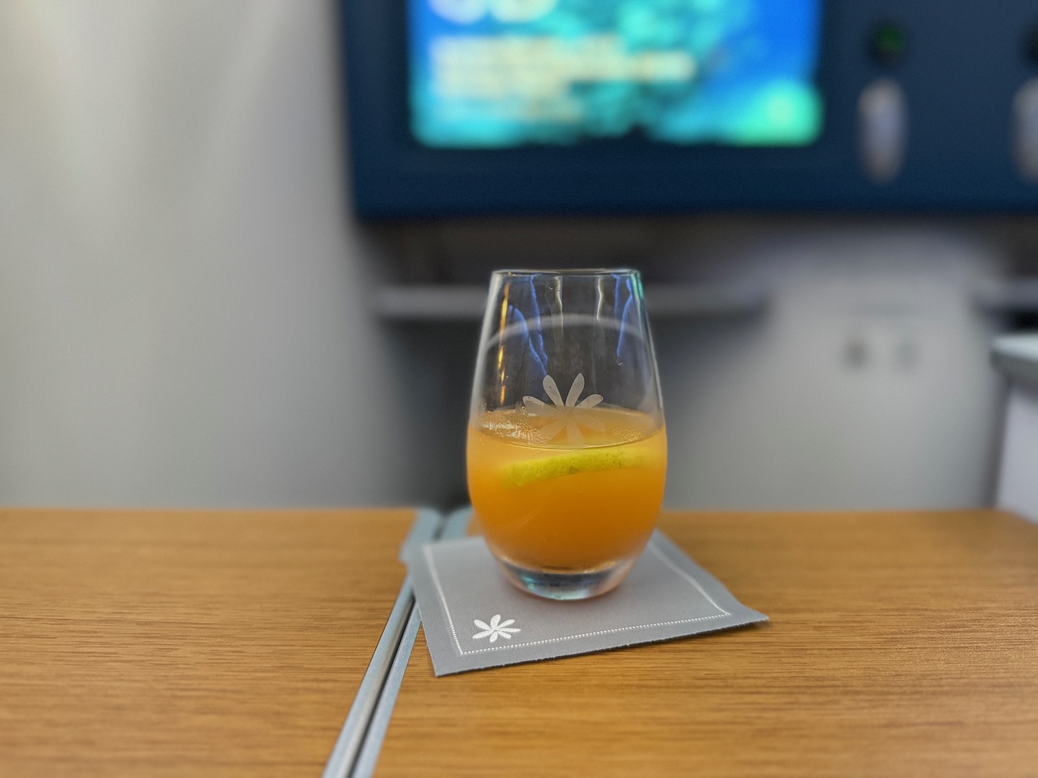 a glass of orange liquid on a table