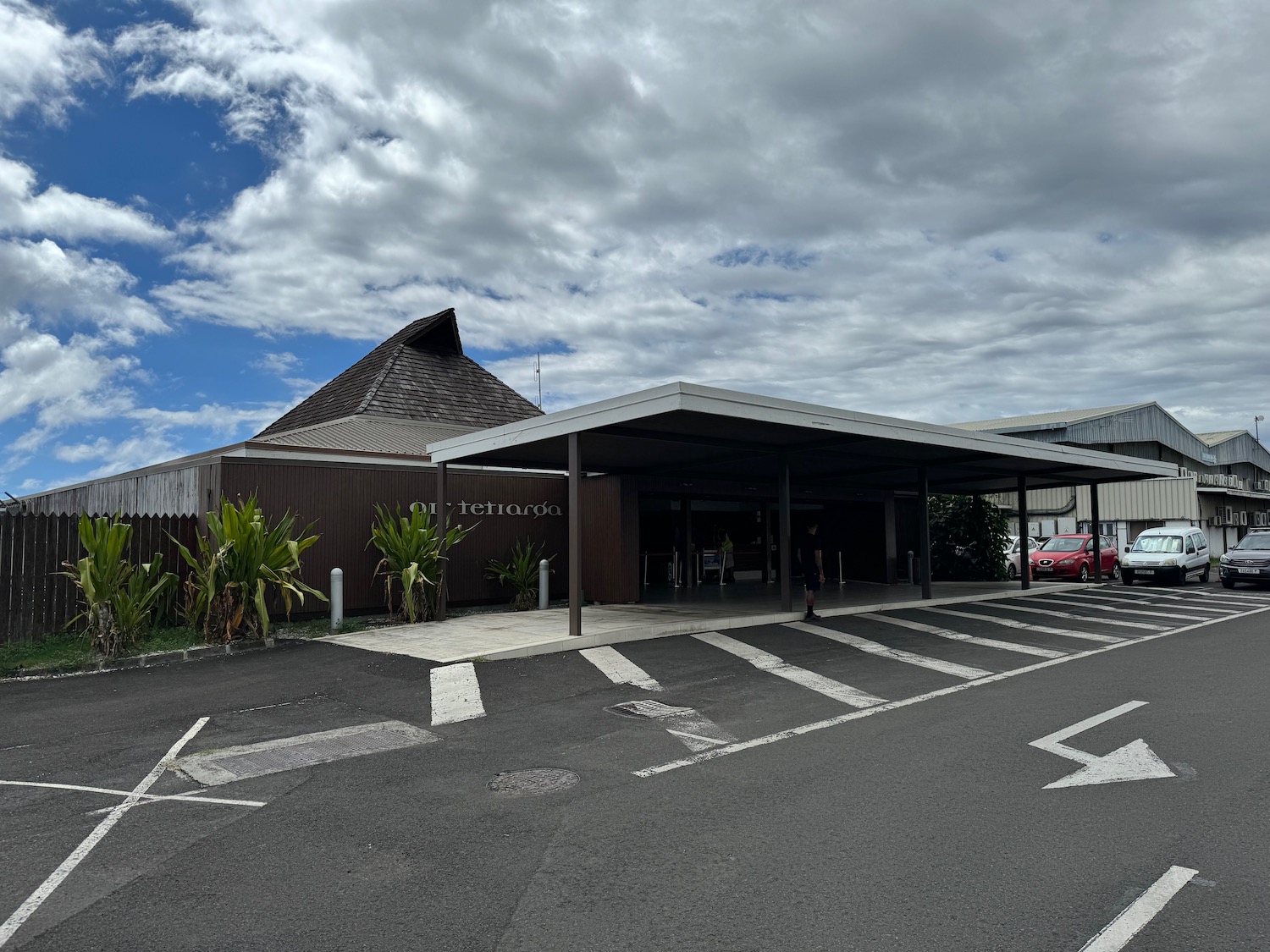 a building with a roof and a parking lot