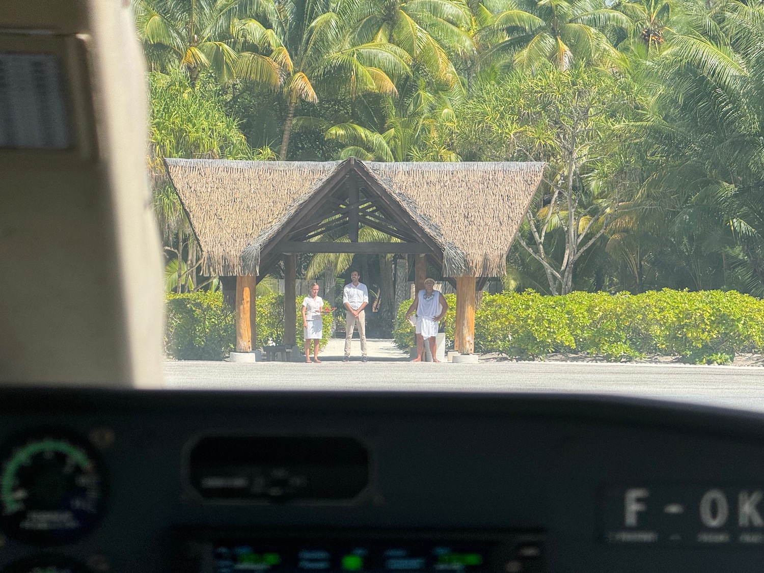 a group of people standing under a hut