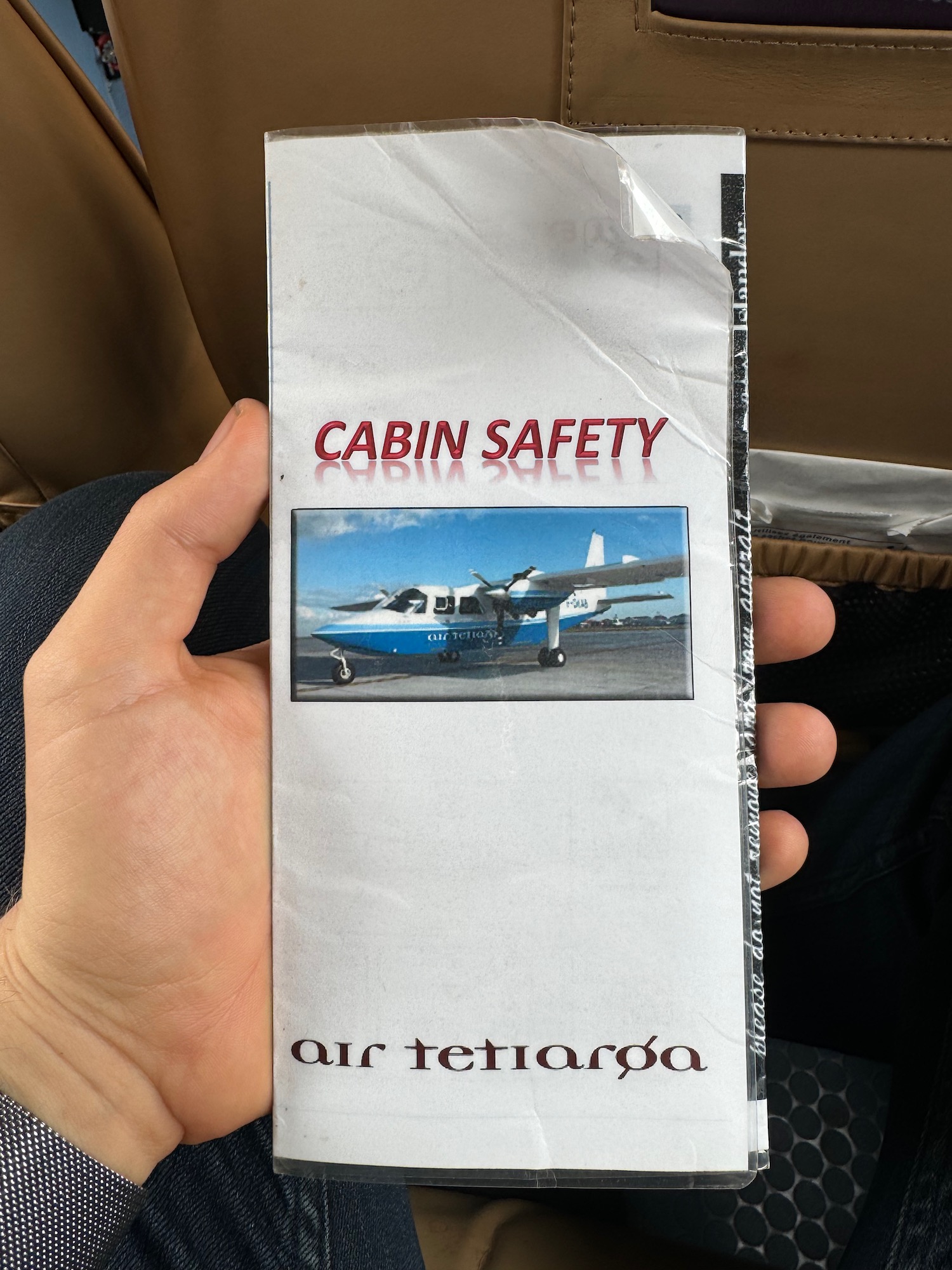 a hand holding a package of a plane