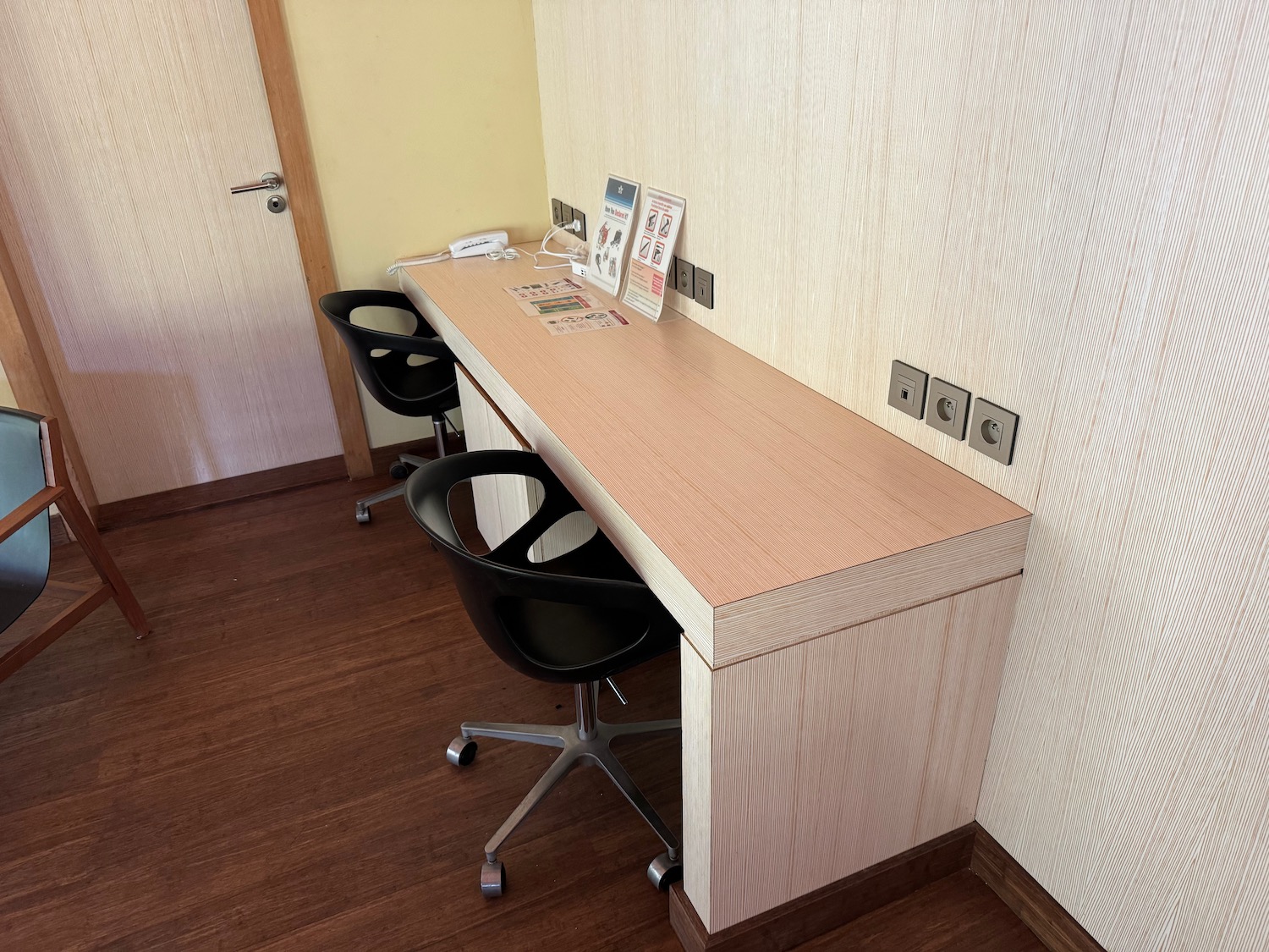 a desk with chairs in a room