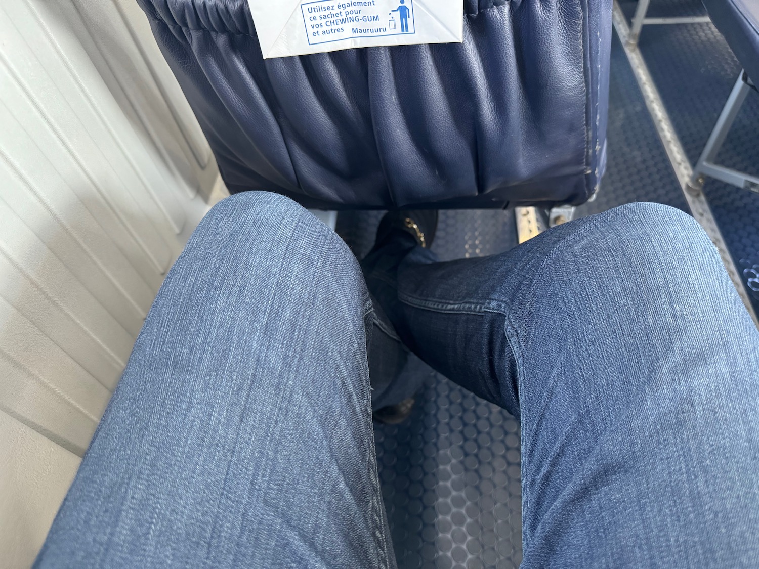 a person's legs and a seat