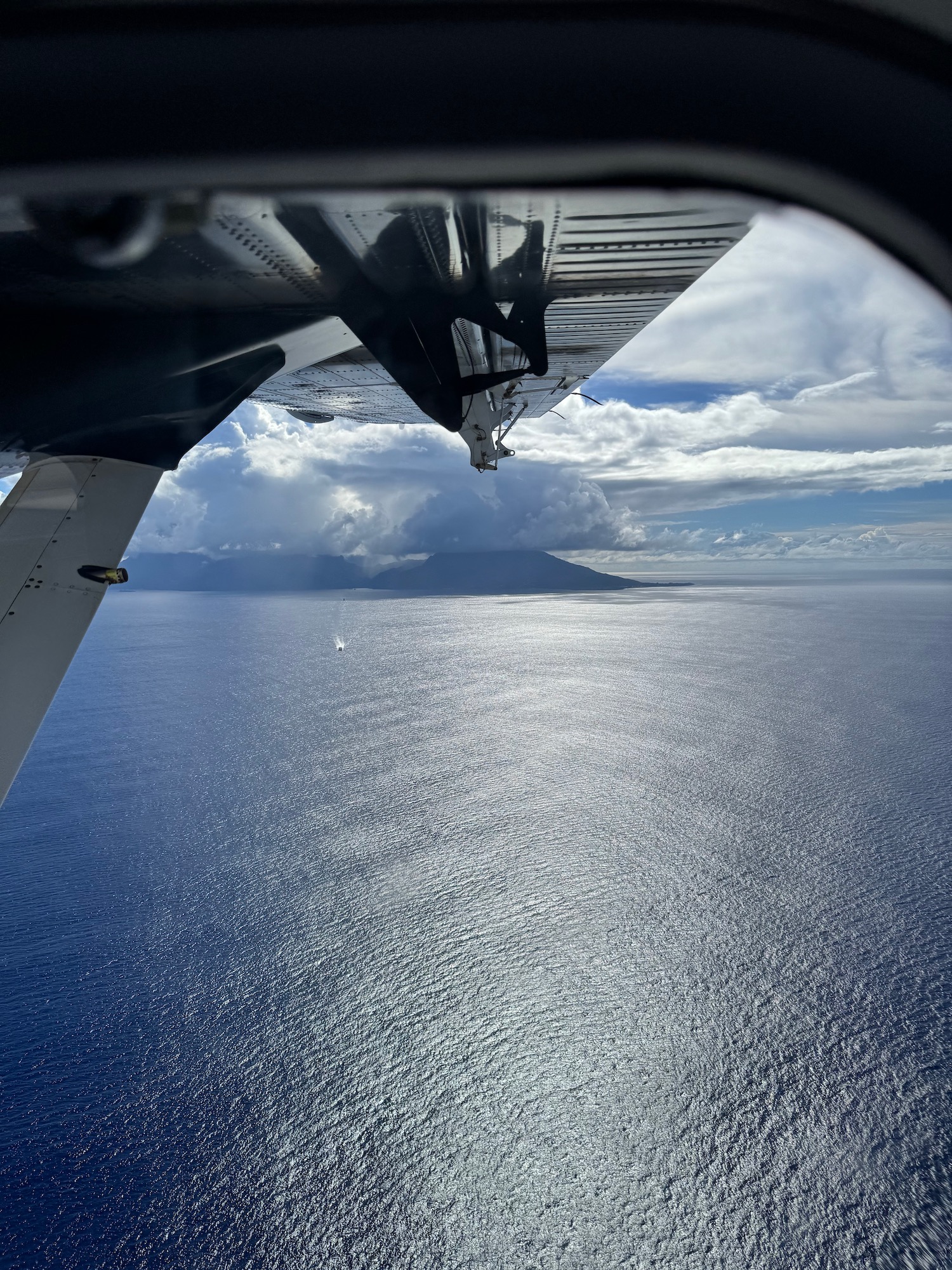 a view of the ocean from a plane wing