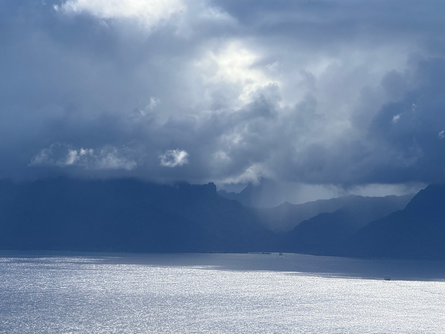 a body of water with mountains in the background