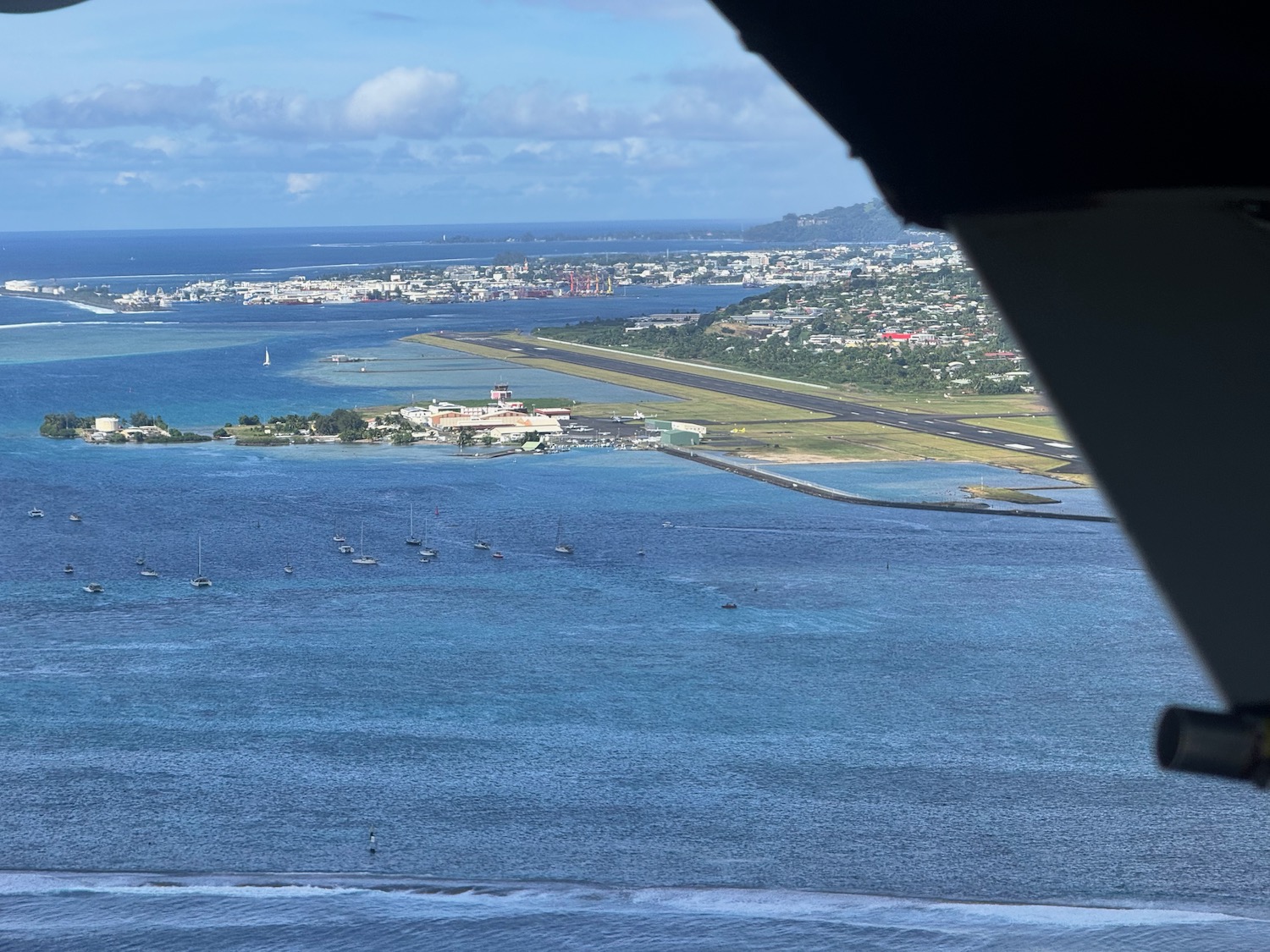 a view of a body of water and a city from an airplane