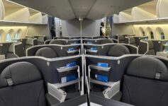 an airplane with seats and a person standing in the back