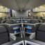 an airplane with seats and a person standing in the back