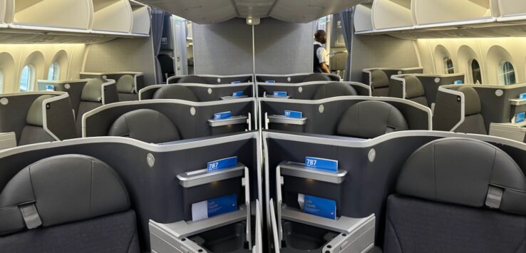 an airplane with seats and a person standing in the back