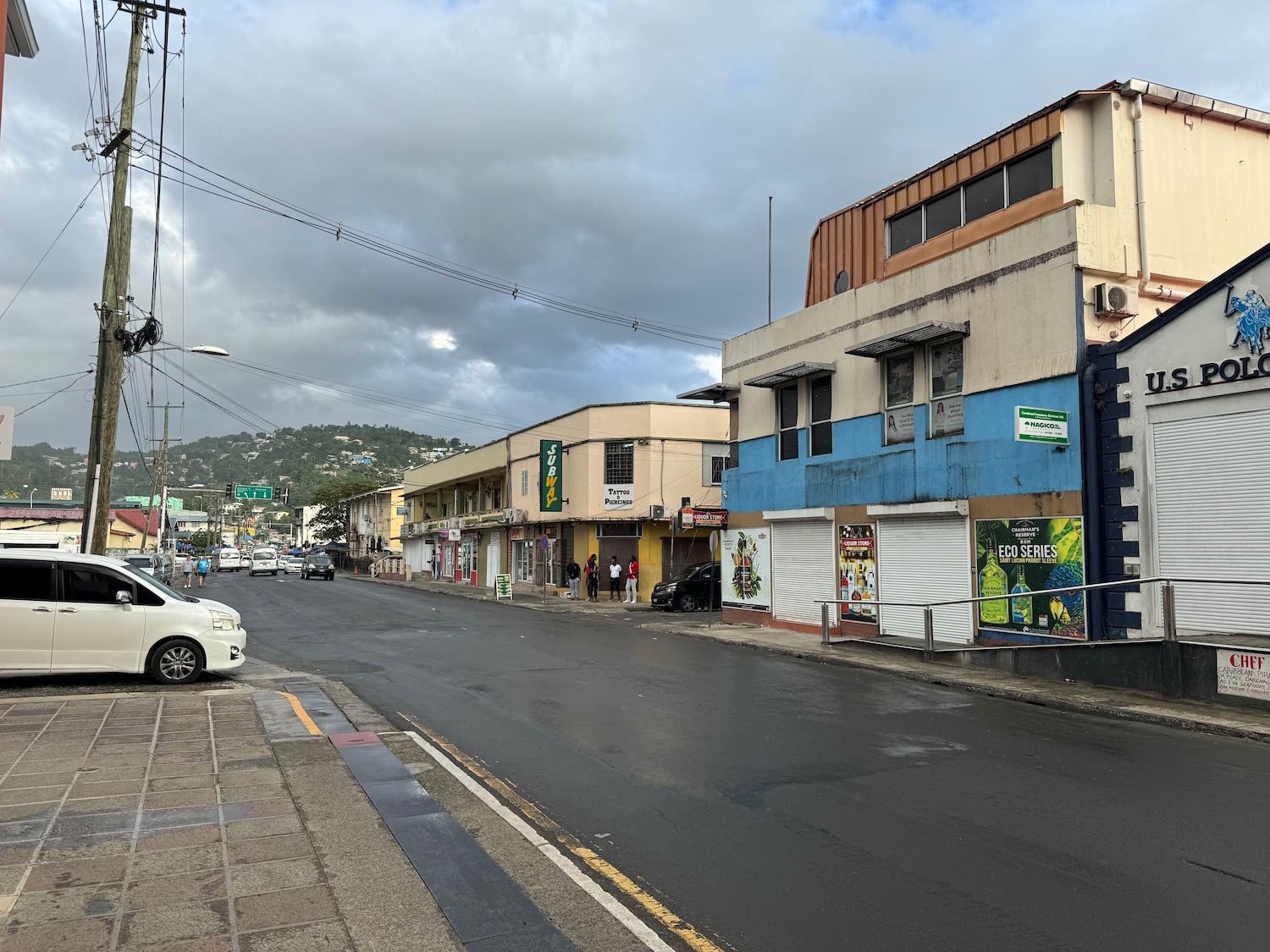 a street with buildings and cars on the side