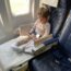 a girl sitting in a plane