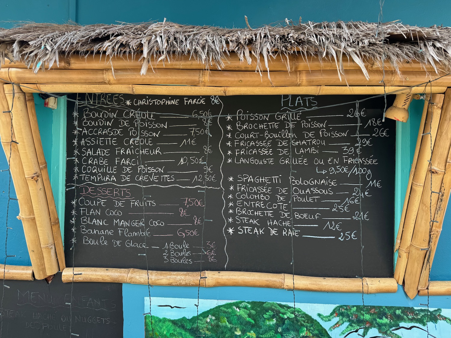 a chalkboard with a straw roof