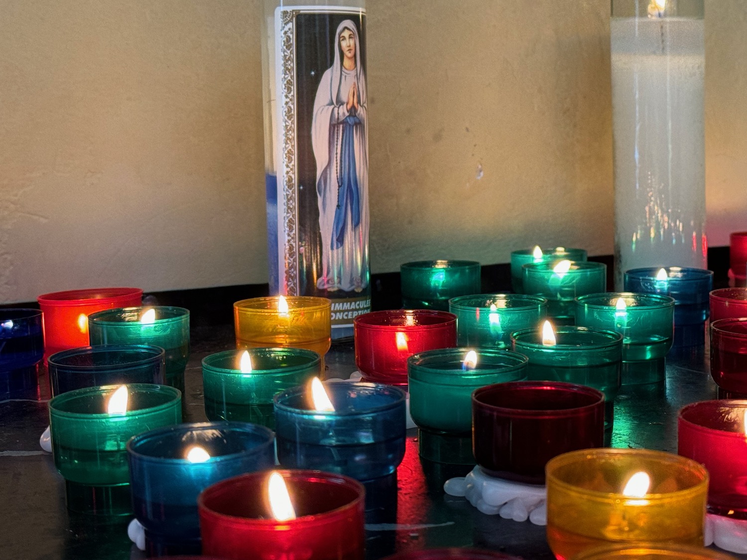 a group of candles with a picture of a woman