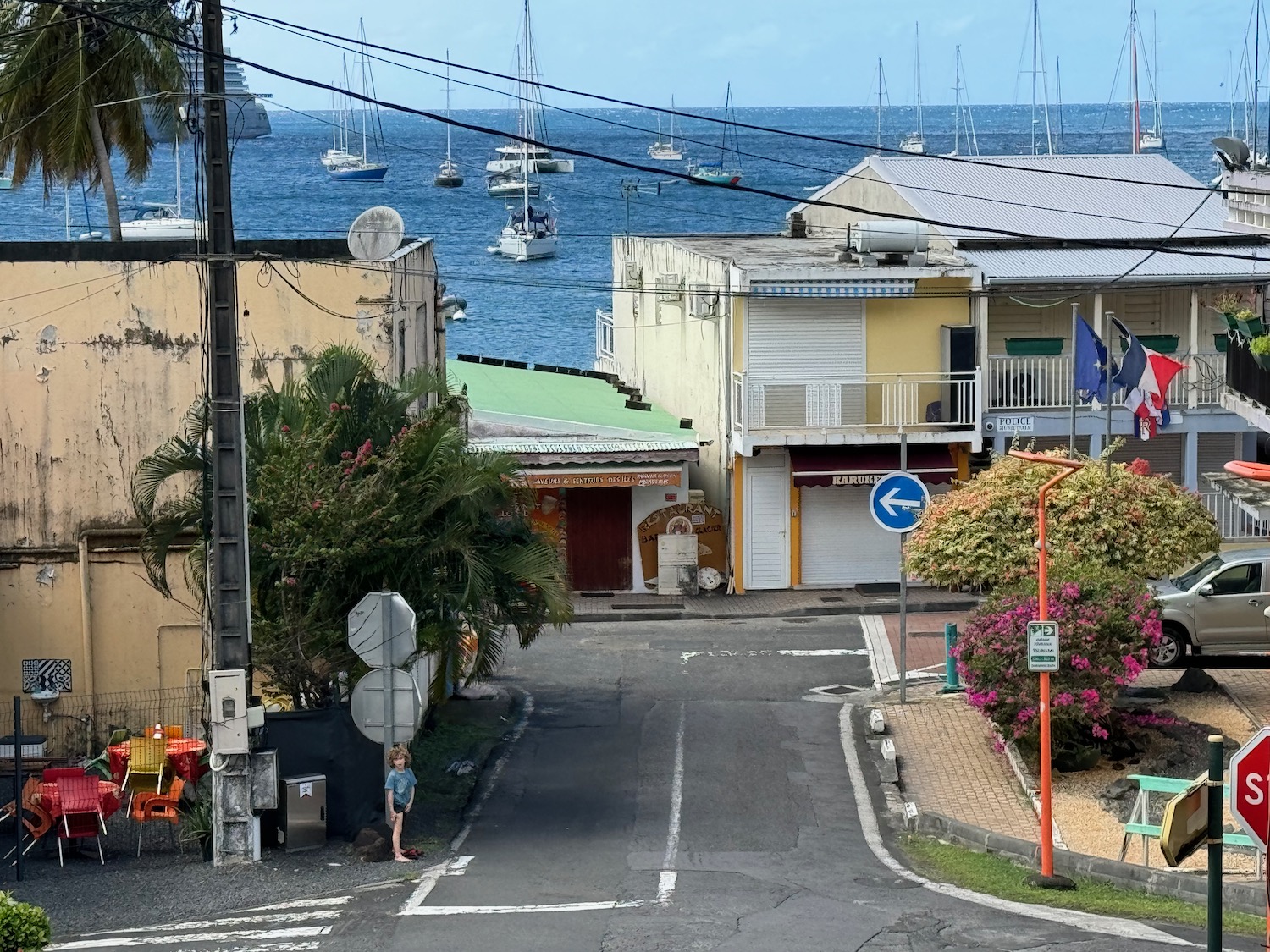 a street with buildings and boats in the water