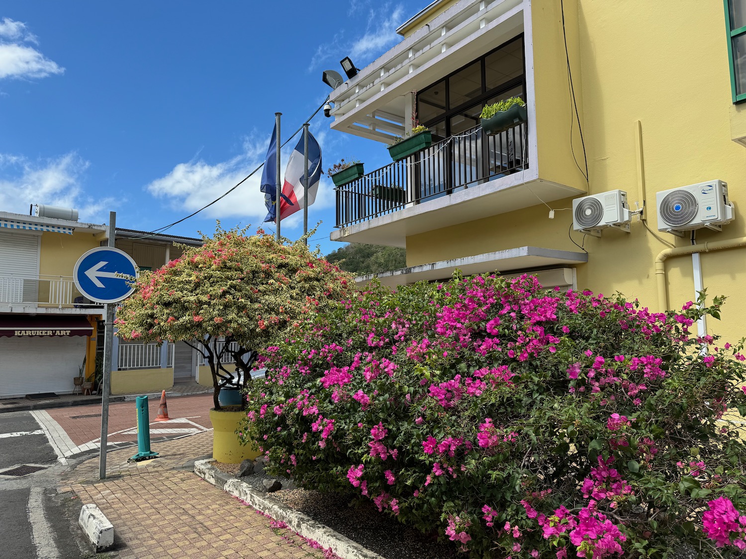 a building with flowers and a sign