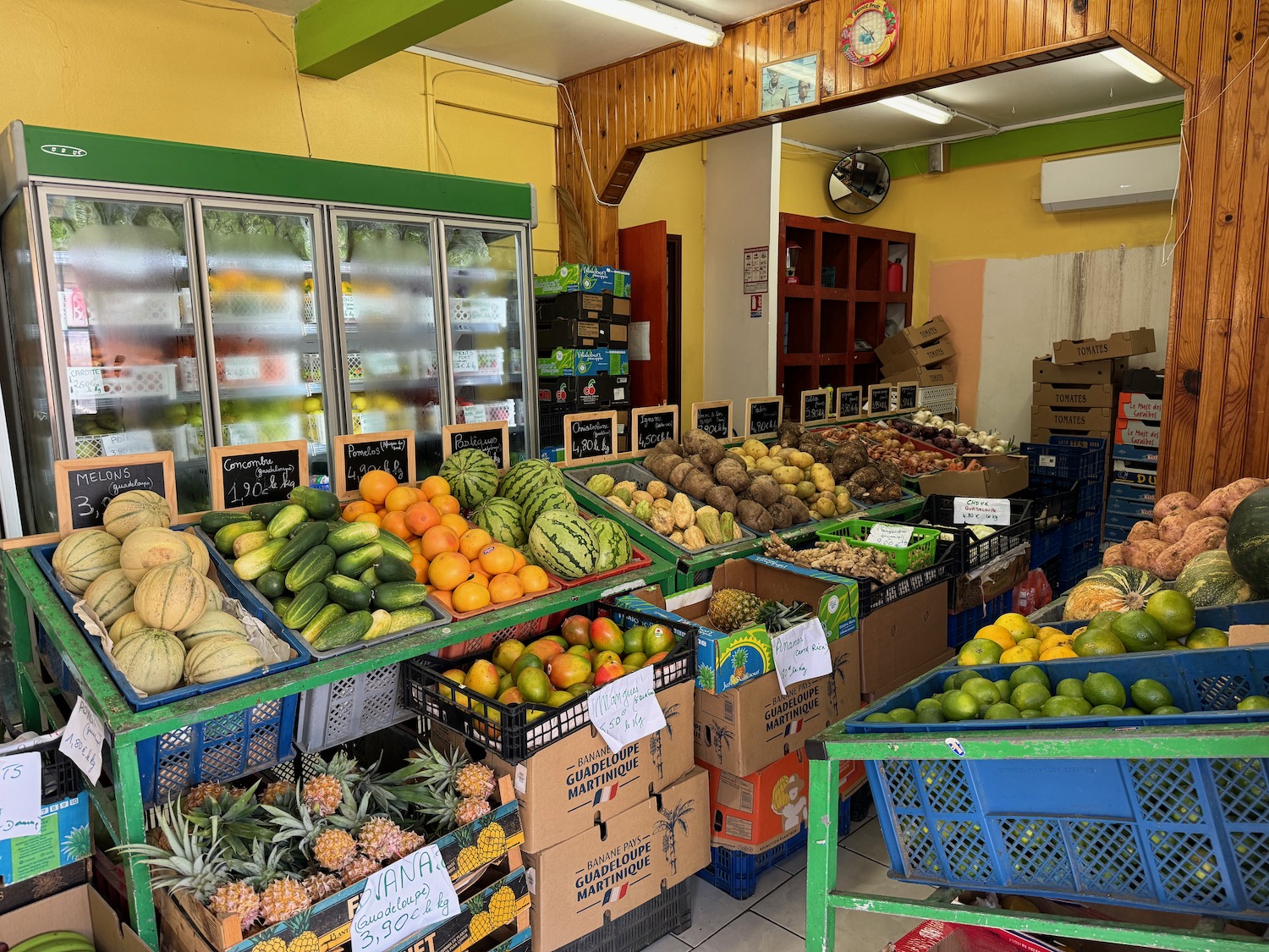 a fruit stand with baskets of fruits