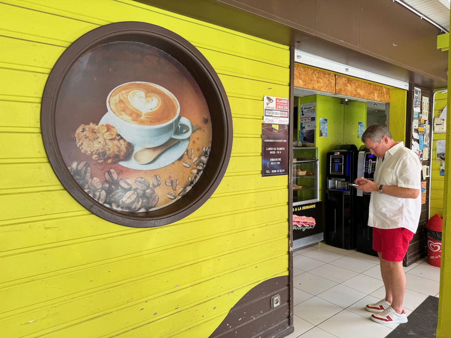 a man standing in front of a coffee machine