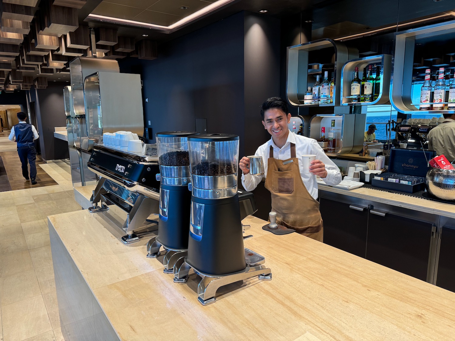 a man standing behind a counter with coffee beans