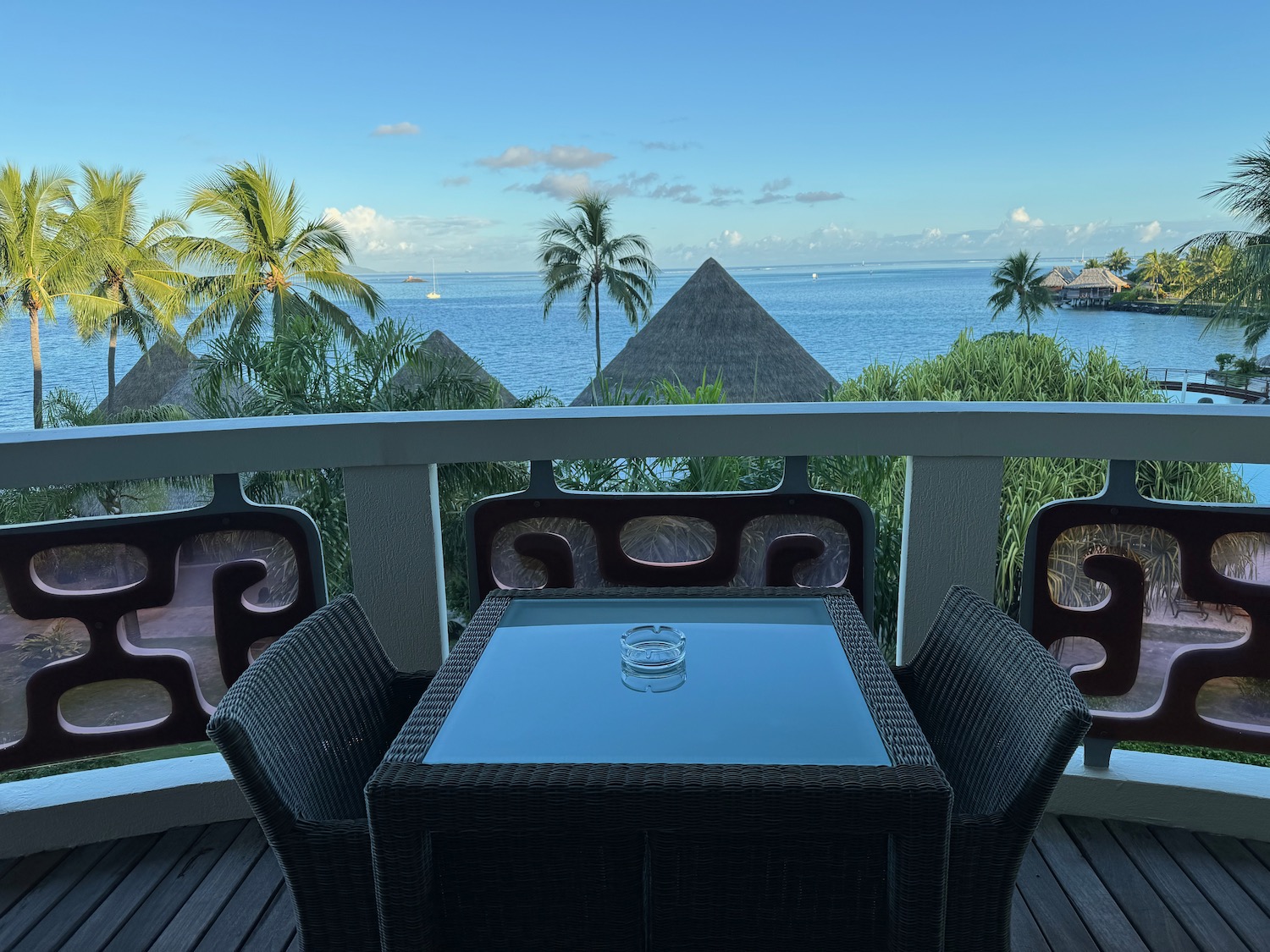 a table and chairs on a deck overlooking a body of water